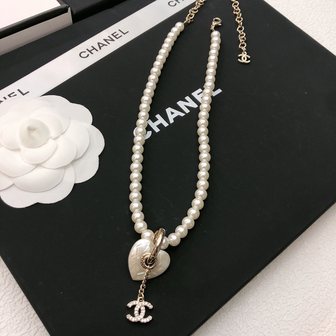 Chanel CC Heart Pearl Pendant Necklace necklace Gold-tone metal white faux pearl clear crystal white mother-of-pearl effect heart charm 40cm with 7cm extender chain