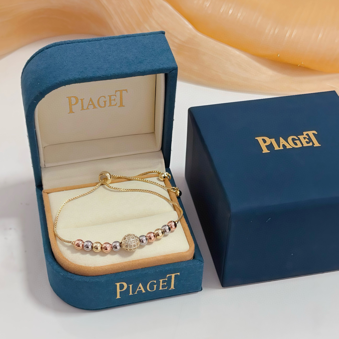 Piaget Possession bracelet tri-tone yellow gold rose gold white gold metal with clear diamond pave accent bead adjustable sliding chain maximum length 22cm