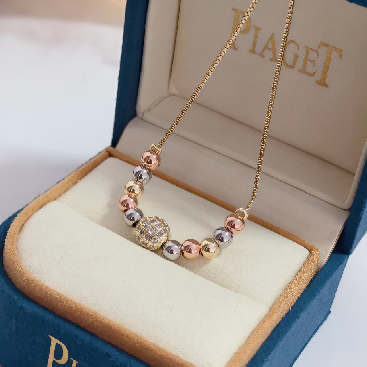 Piaget Possession bracelet tri-tone yellow gold rose gold white gold metal with clear diamond pave accent bead adjustable sliding chain maximum length 22cm