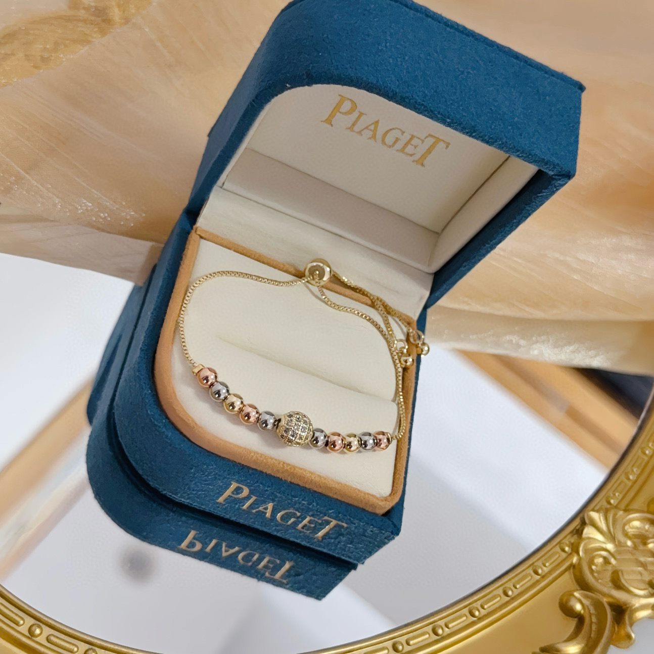 Piaget Possession bracelet tri-tone yellow gold rose gold white gold metal with clear diamond pave accent bead adjustable sliding chain maximum length 22cm