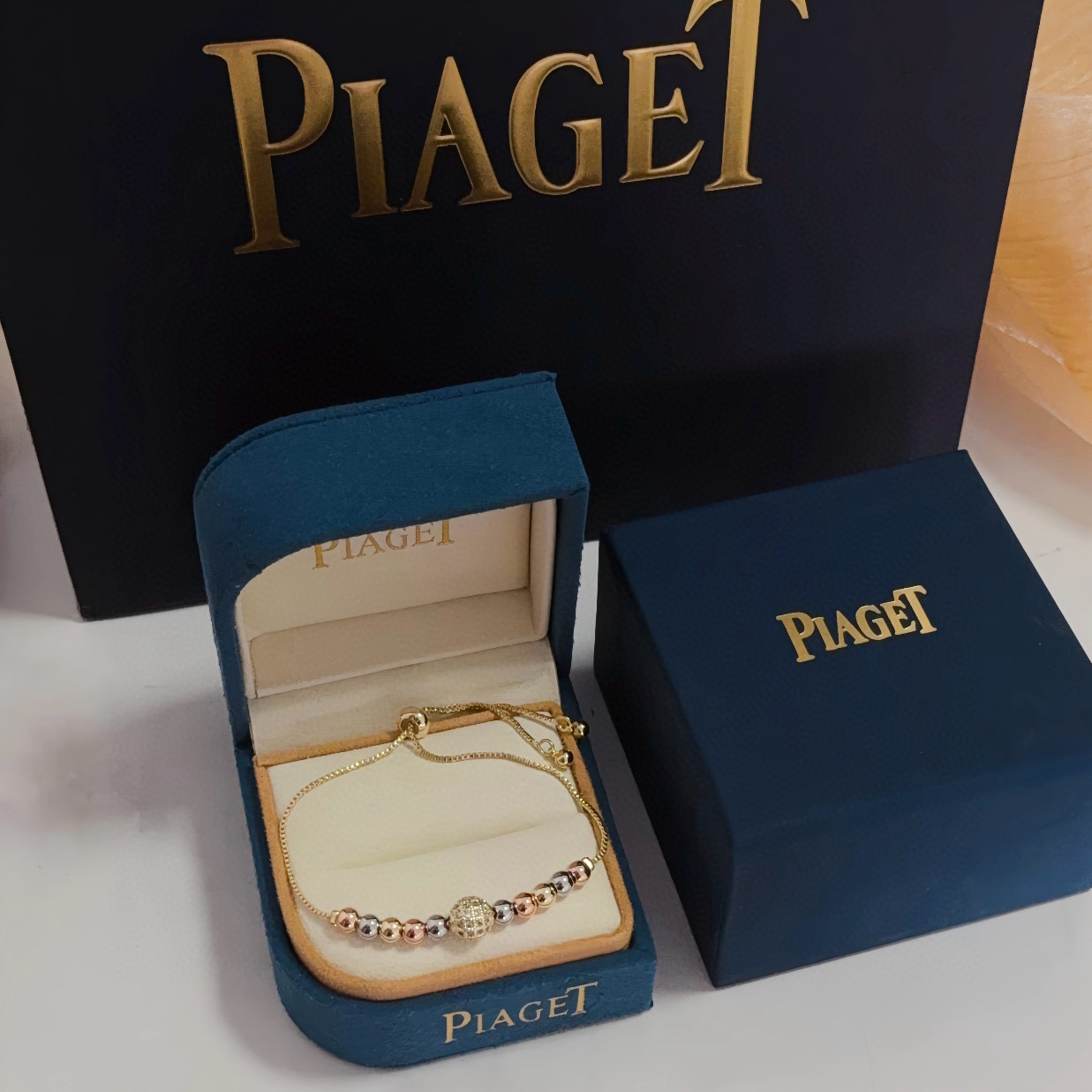 Piaget Possession bracelet tri-tone yellow gold rose gold white gold metal with clear diamond pave accent bead adjustable sliding chain maximum length 22cm