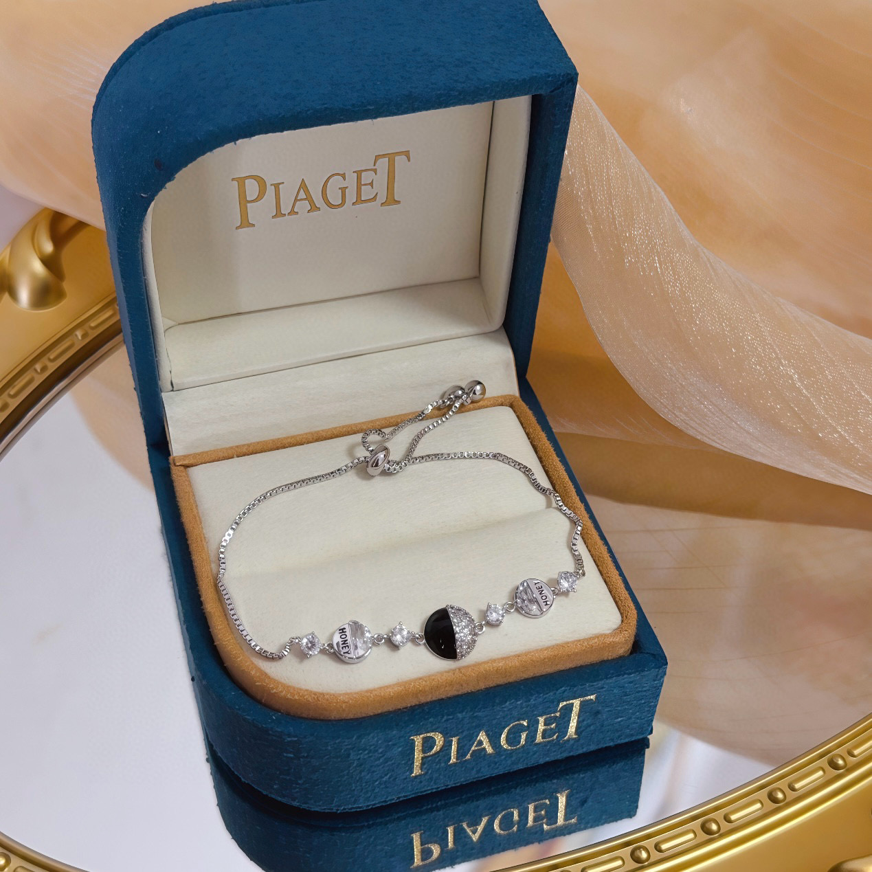Piaget Possession bracelet silver-toned metal with clear cubic zirconia and black onyx accent gold-toned variant with clear cubic zirconia and red enamel accent adjustable 16-22cm