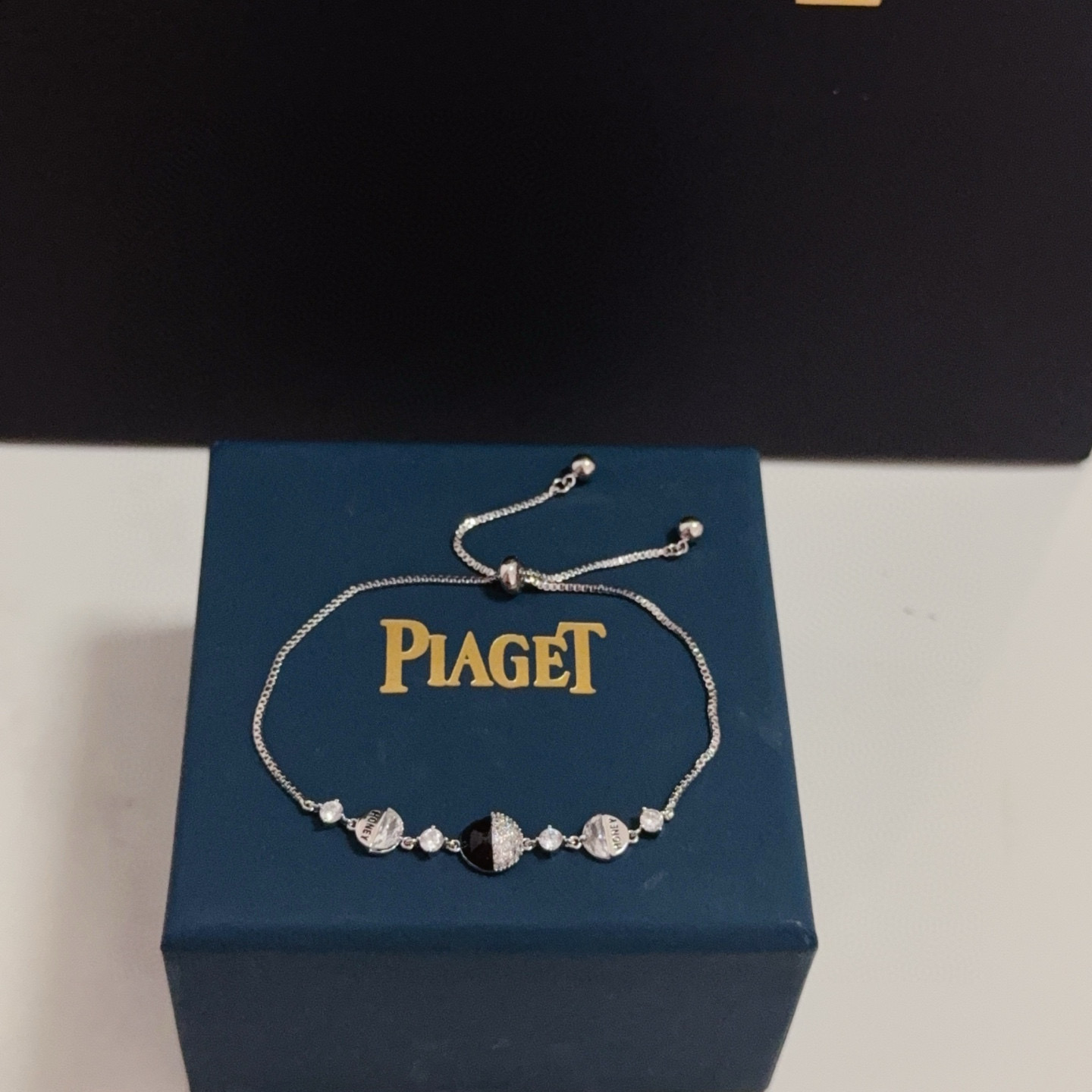 Piaget Possession bracelet silver-toned metal with clear cubic zirconia and black onyx accent gold-toned variant with clear cubic zirconia and red enamel accent adjustable 16-22cm