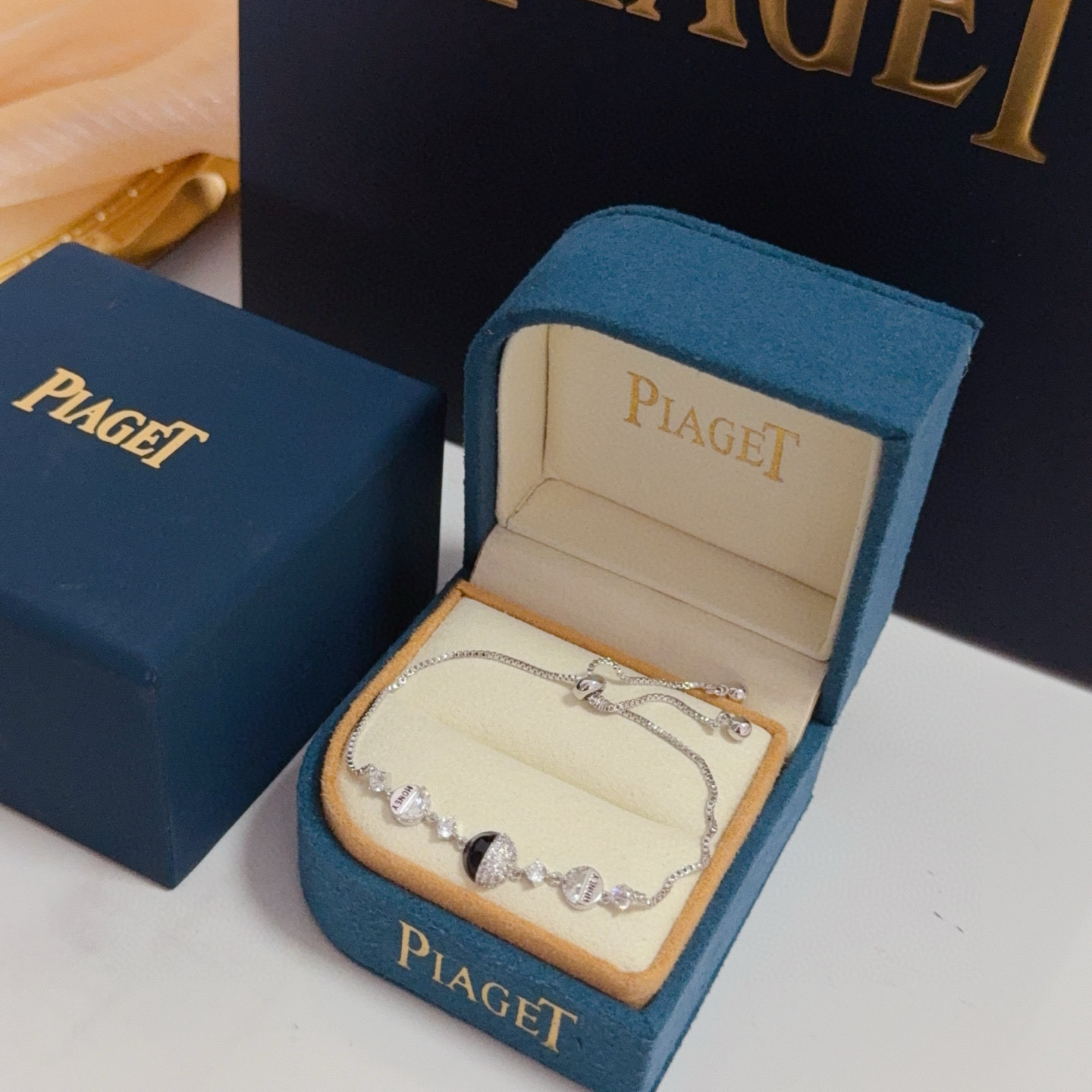 Piaget Possession bracelet silver-toned metal with clear cubic zirconia and black onyx accent gold-toned variant with clear cubic zirconia and red enamel accent adjustable 16-22cm
