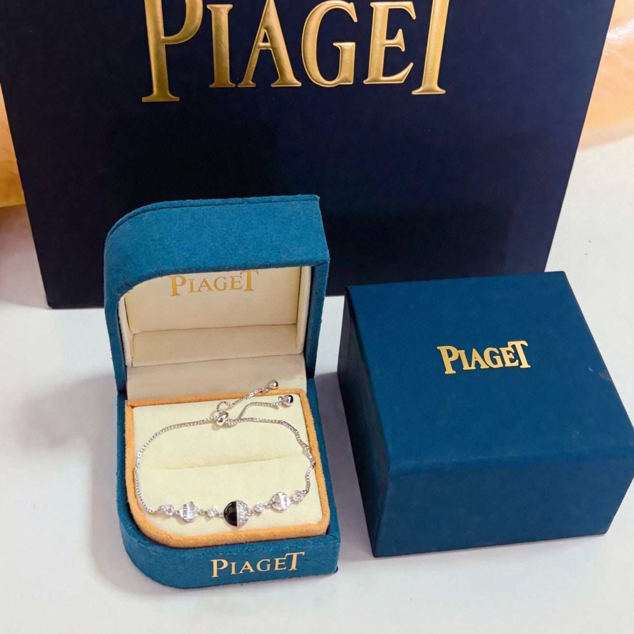 Piaget Possession bracelet silver-toned metal with clear cubic zirconia and black onyx accent gold-toned variant with clear cubic zirconia and red enamel accent adjustable 16-22cm