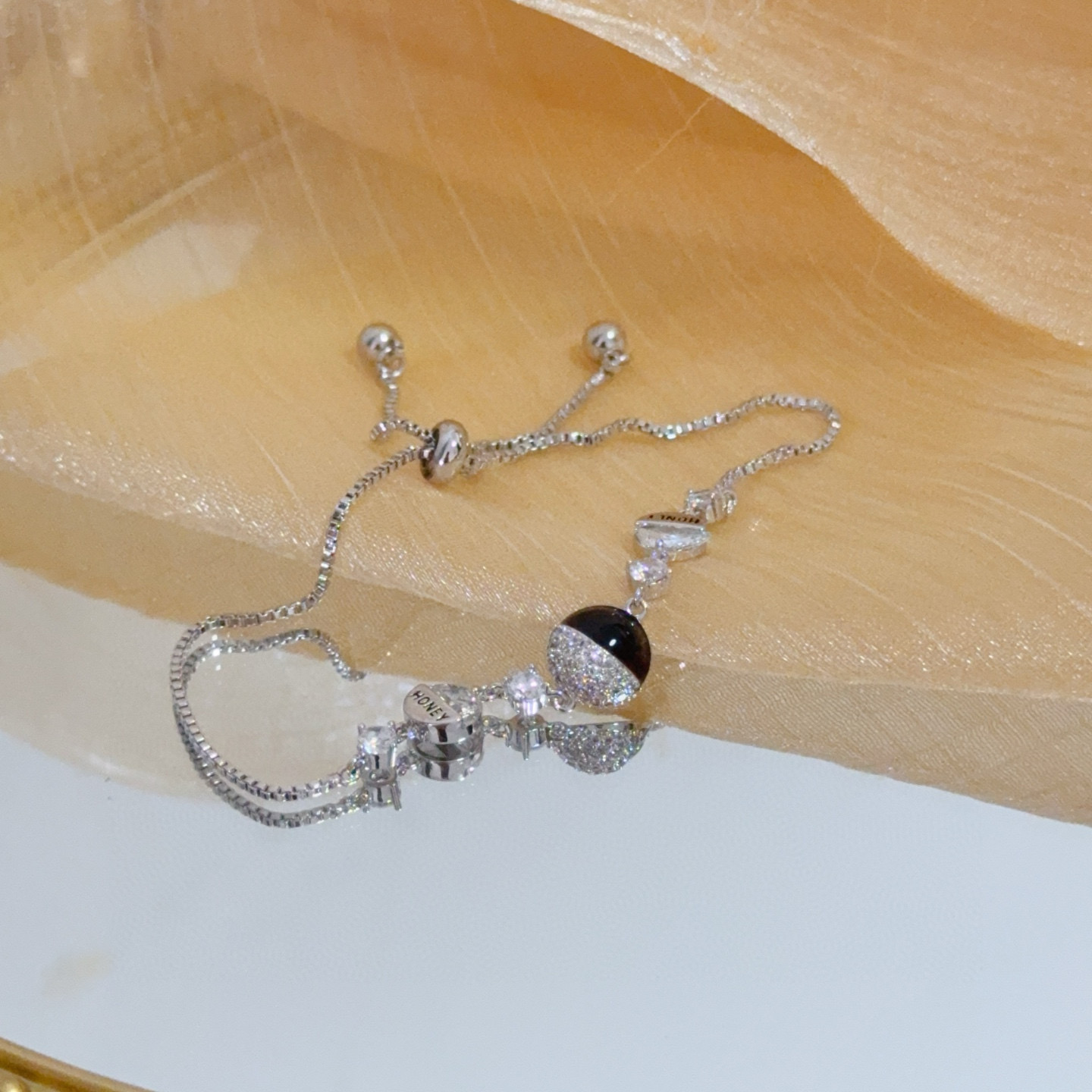 Piaget Possession bracelet silver-toned metal with clear cubic zirconia and black onyx accent gold-toned variant with clear cubic zirconia and red enamel accent adjustable 16-22cm