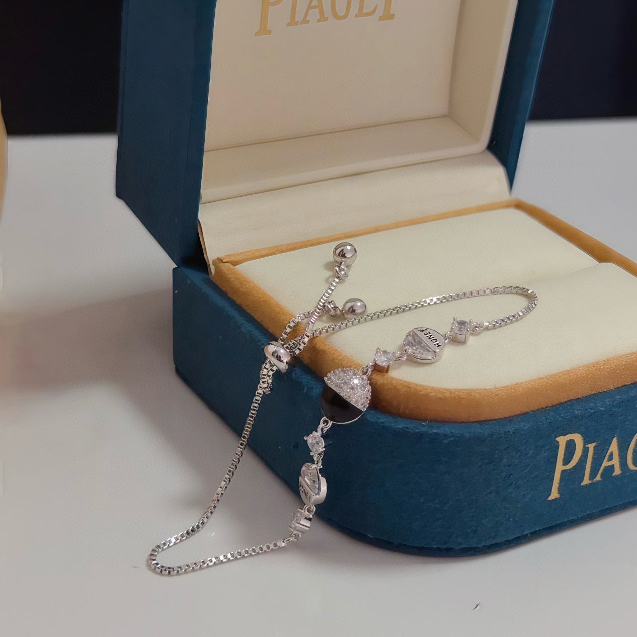 Piaget Possession bracelet silver-toned metal with clear cubic zirconia and black onyx accent gold-toned variant with clear cubic zirconia and red enamel accent adjustable 16-22cm