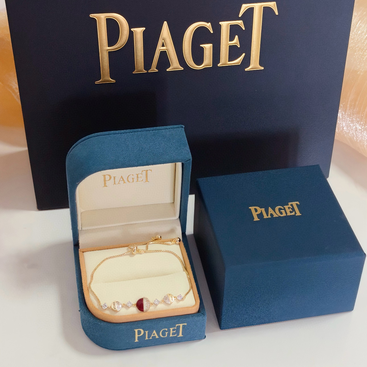 Piaget Possession bracelet yellow gold metal clear diamond-like crystals deep red enamel accent adjustable sliding chain 16-20cm