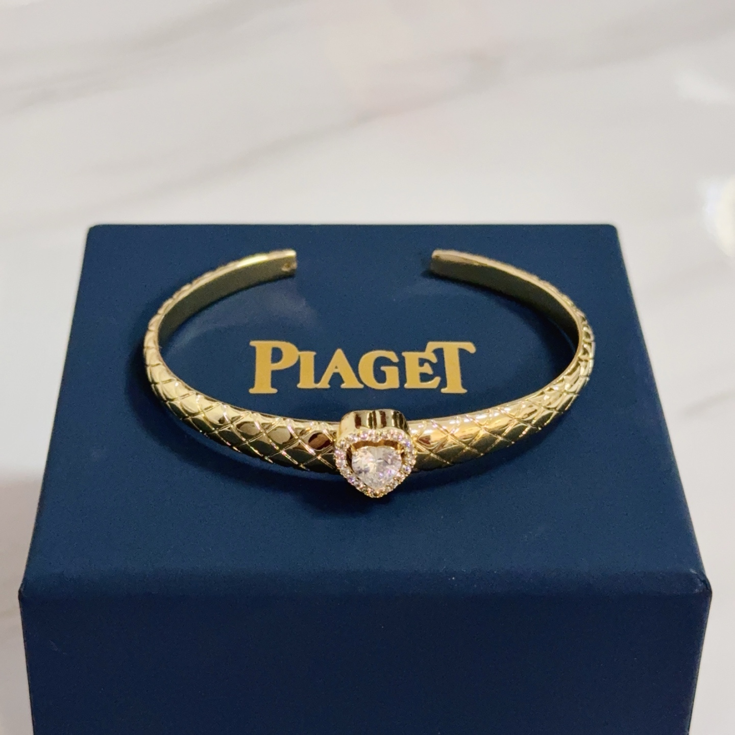 Piaget Heart Diamond Quilted Open Bangle bracelet 18k yellow gold with clear heart-cut diamond and diamond halo 17cm inner circumference