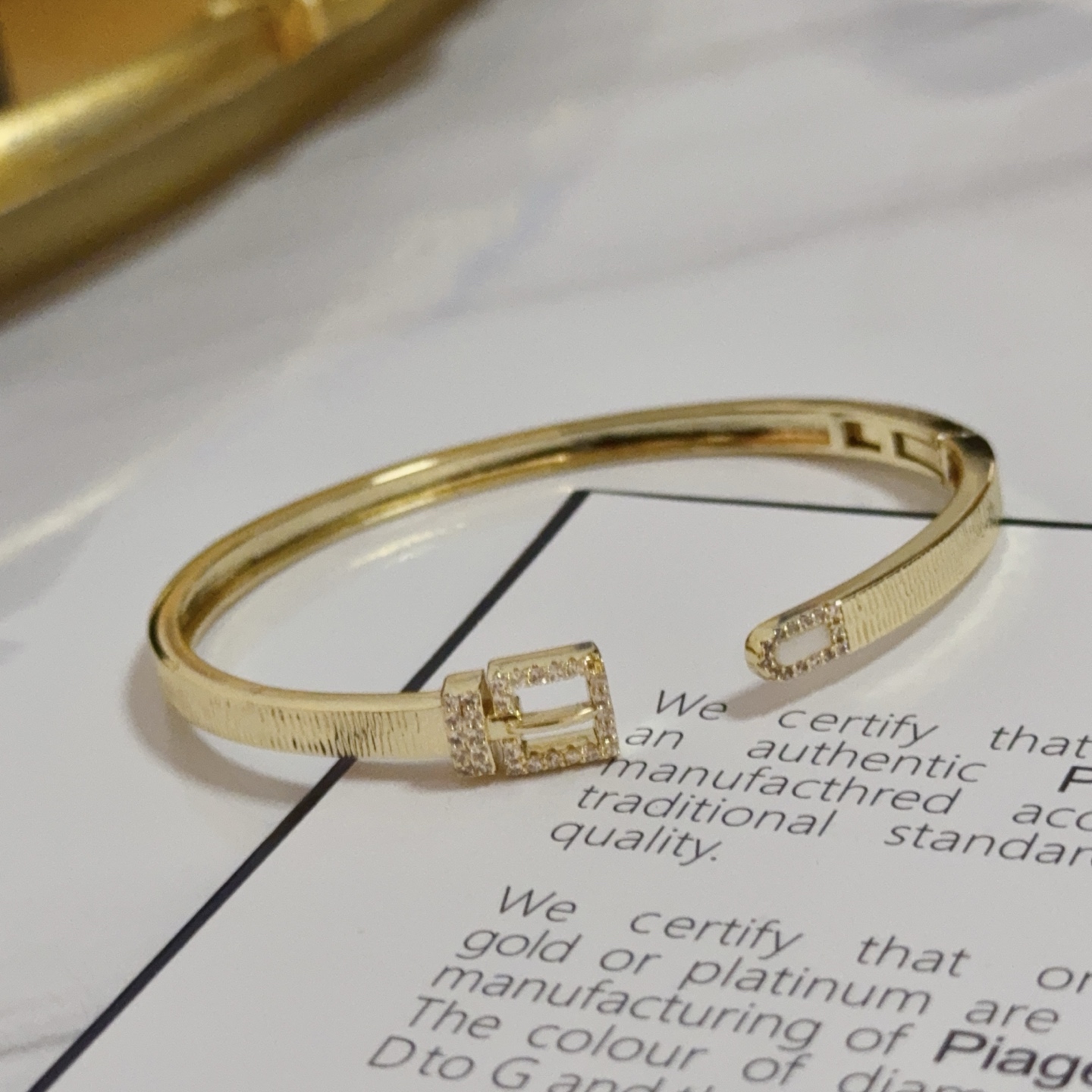 Piaget Possession Buckle Cuff bracelet 18k yellow gold with clear diamond accents and white mother-of-pearl inlay 17cm inner circumference