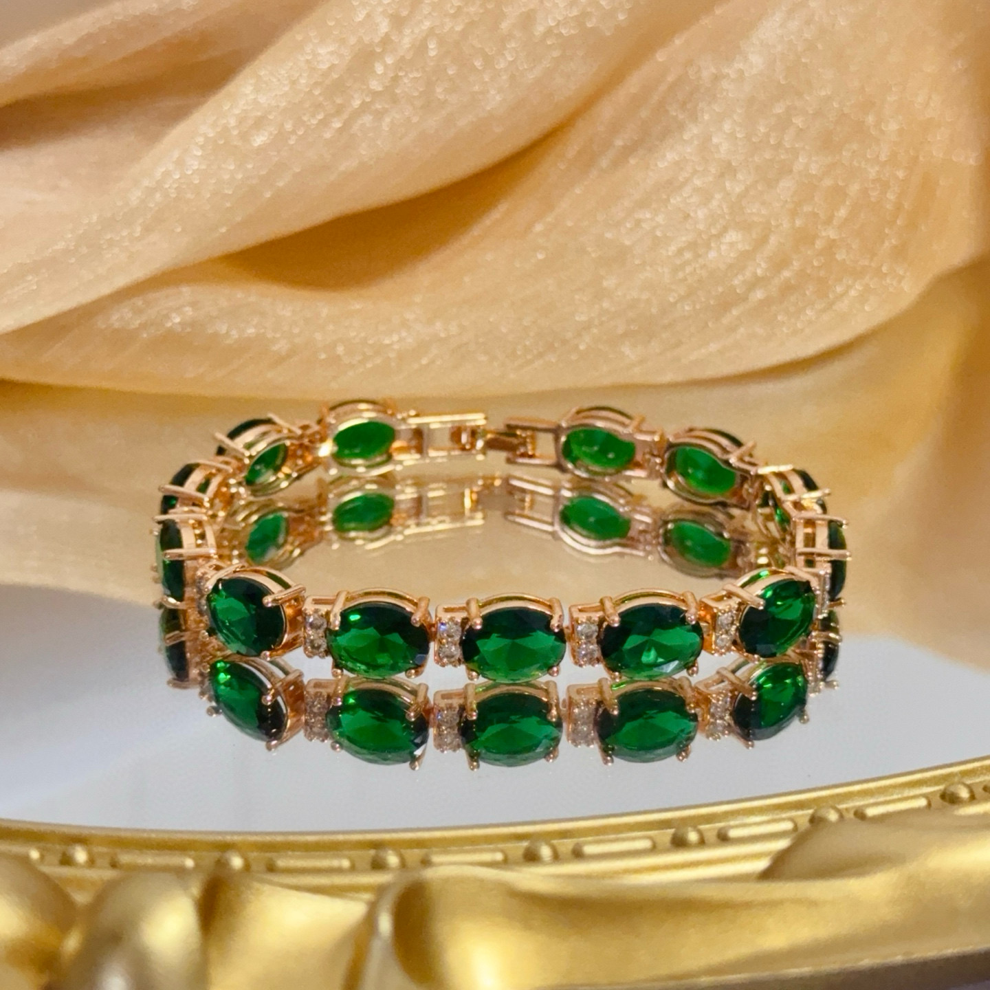 Piaget Oval Green Gemstone Line Bracelet bracelet Rose gold metal with vibrant green oval gemstones and small clear accent stones 18cm