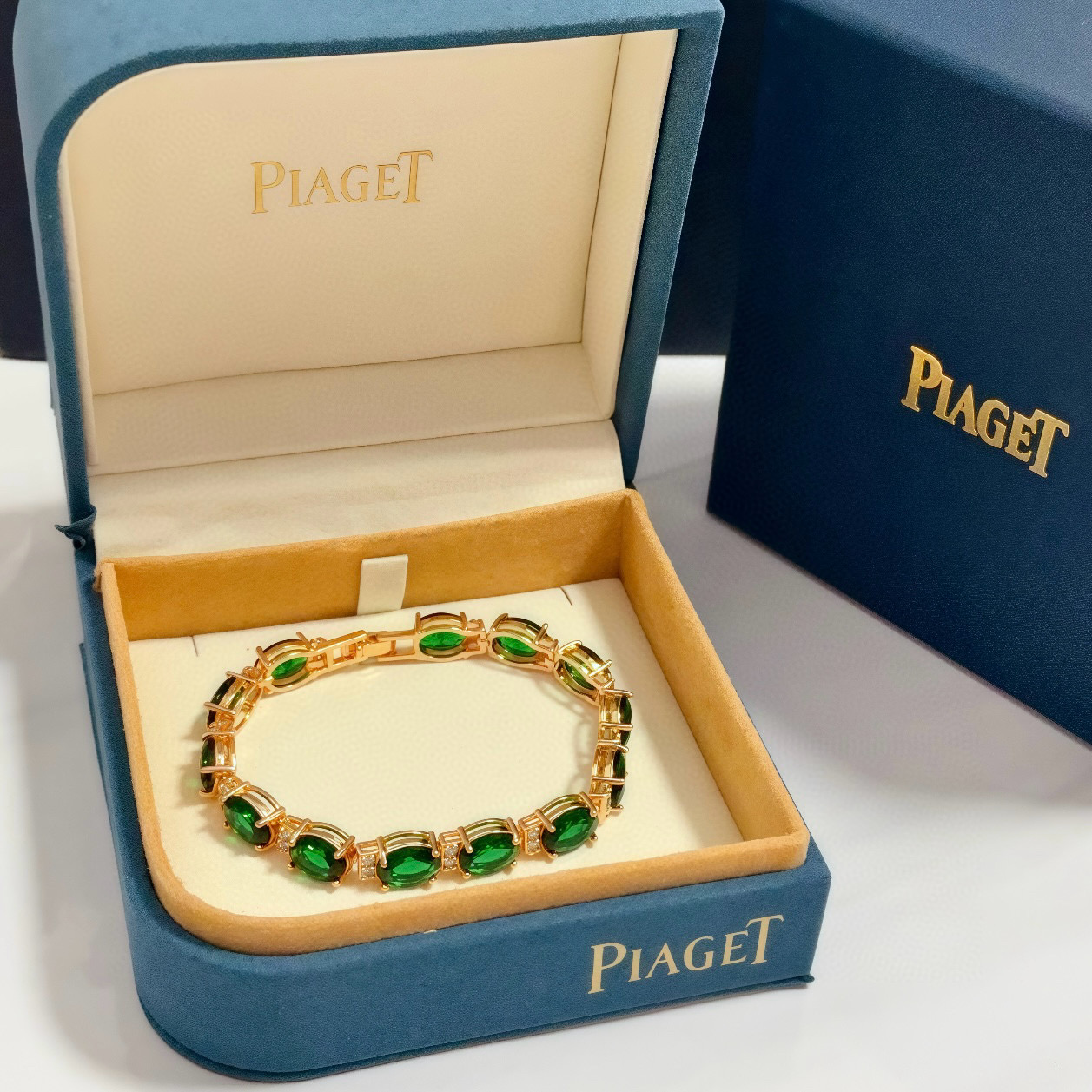 Piaget Oval Green Gemstone Line Bracelet bracelet Rose gold metal with vibrant green oval gemstones and small clear accent stones 18cm