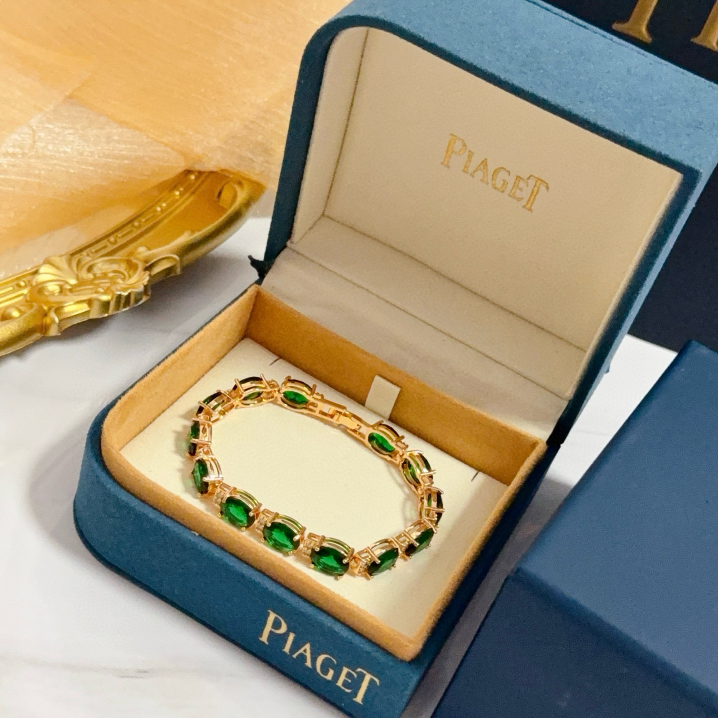 Piaget Oval Green Gemstone Line Bracelet bracelet Rose gold metal with vibrant green oval gemstones and small clear accent stones 18cm