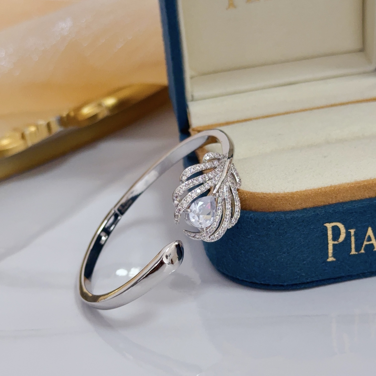 Piaget Feather Diamond Open Bangle bracelet silver-toned white gold metal with clear diamond and pear-shaped clear gemstone accents 17cm inner circumference
