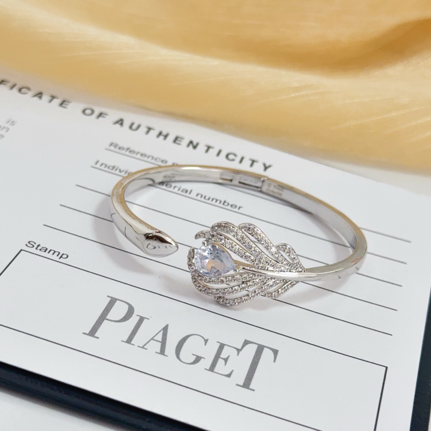 Piaget Feather Diamond Open Bangle bracelet silver-toned white gold metal with clear diamond and pear-shaped clear gemstone accents 17cm inner circumference