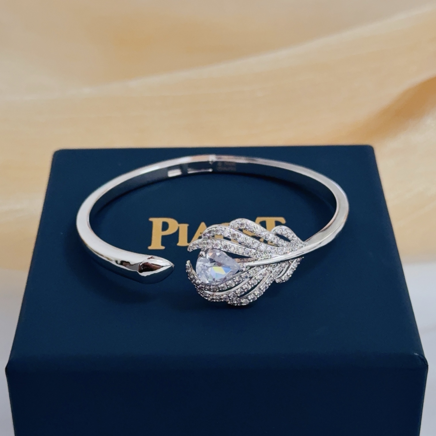 Piaget Feather Diamond Open Bangle bracelet silver-toned white gold metal with clear diamond and pear-shaped clear gemstone accents 17cm inner circumference