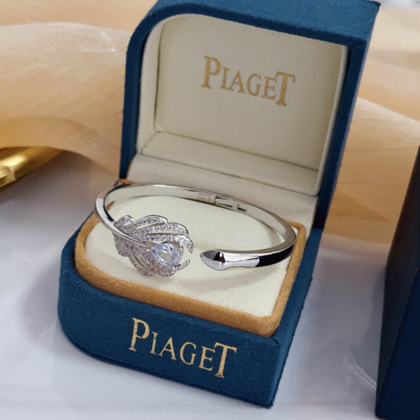 Piaget Feather Diamond Open Bangle bracelet silver-toned white gold metal with clear diamond and pear-shaped clear gemstone accents 17cm inner circumference
