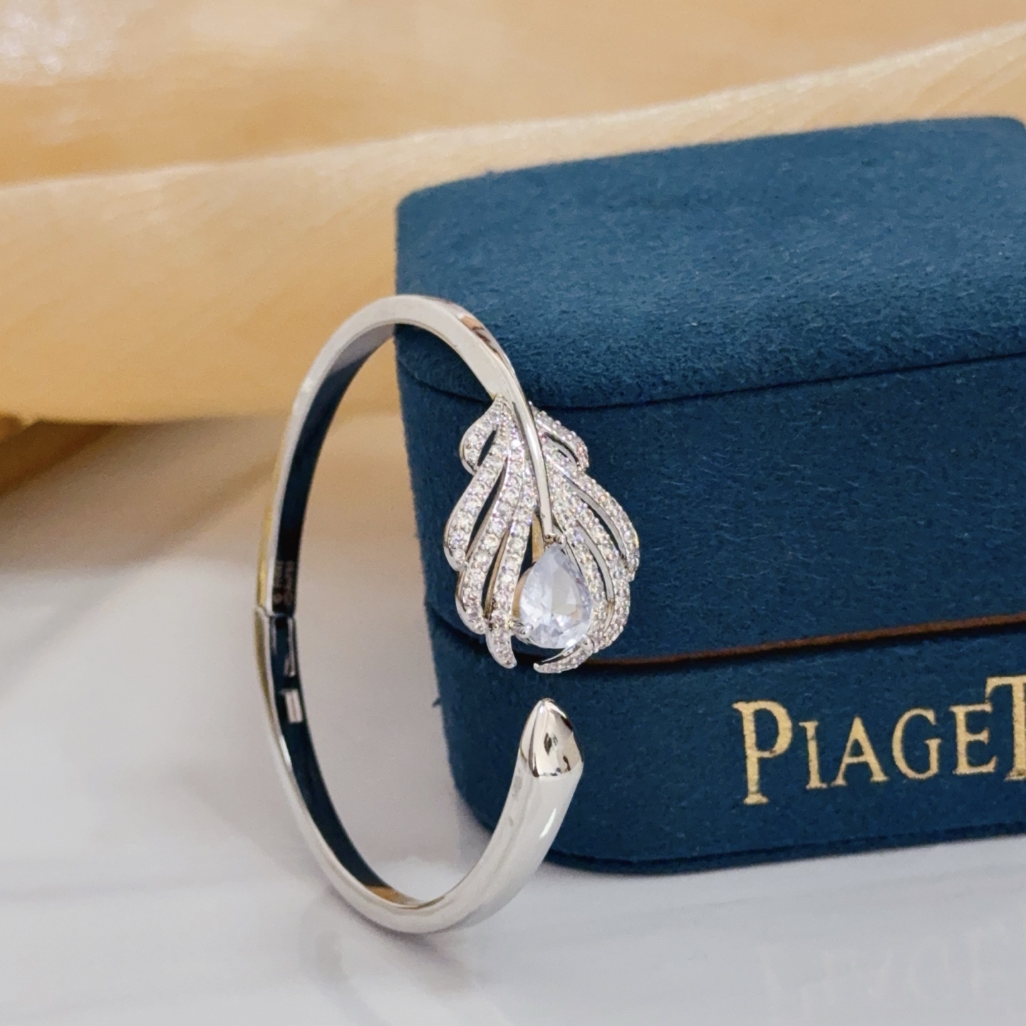 Piaget Feather Diamond Open Bangle bracelet silver-toned white gold metal with clear diamond and pear-shaped clear gemstone accents 17cm inner circumference
