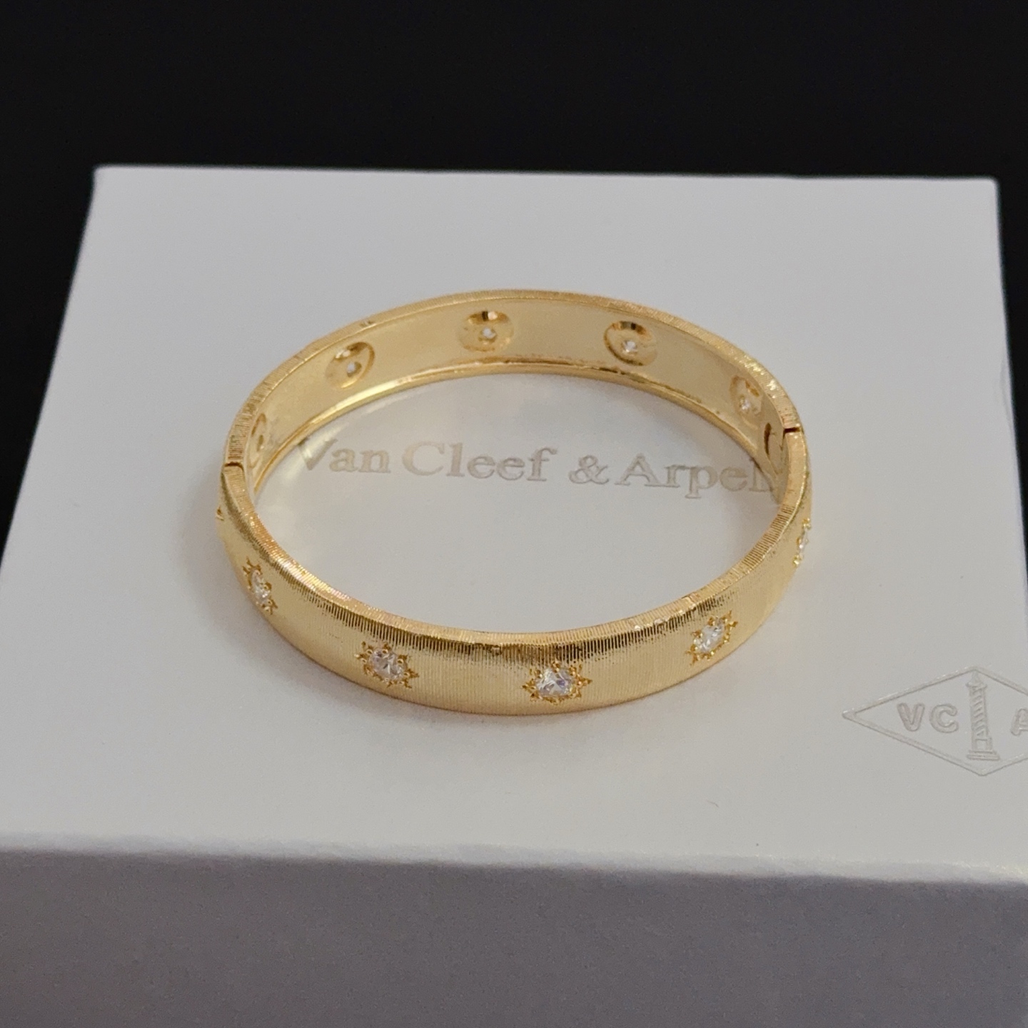 Van Cleef Arpels Four-Leaf Clover Lucky Pattern Multi-layered Carved Bangle bracelet yellow gold metal with clear diamond-like accent stones 17cm inner circumference