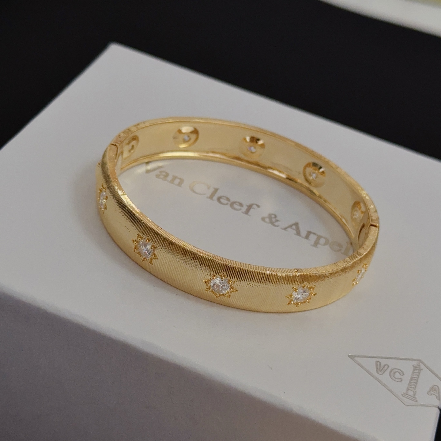 Van Cleef Arpels Four-Leaf Clover Lucky Pattern Multi-layered Carved Bangle bracelet yellow gold metal with clear diamond-like accent stones 17cm inner circumference