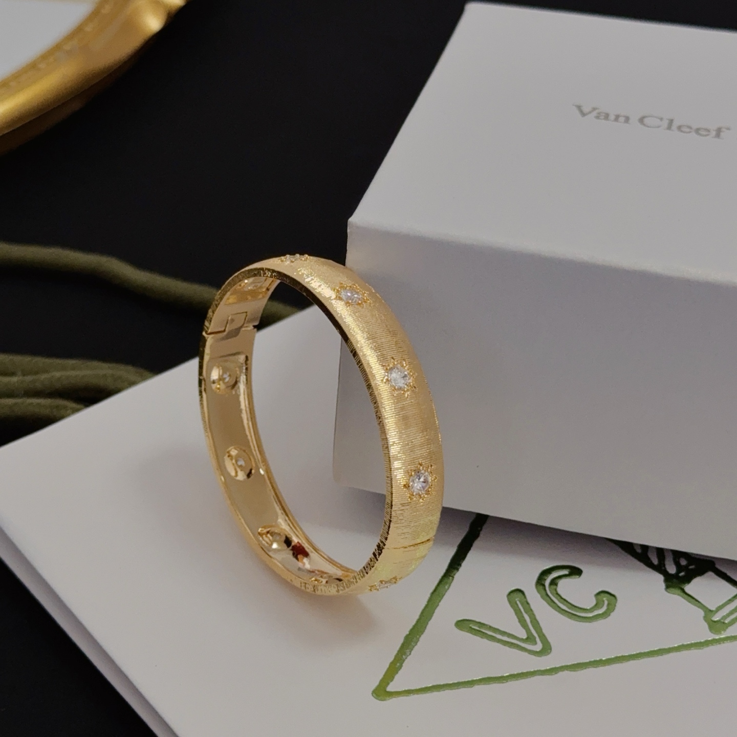 Van Cleef Arpels Four-Leaf Clover Lucky Pattern Multi-layered Carved Bangle bracelet yellow gold metal with clear diamond-like accent stones 17cm inner circumference