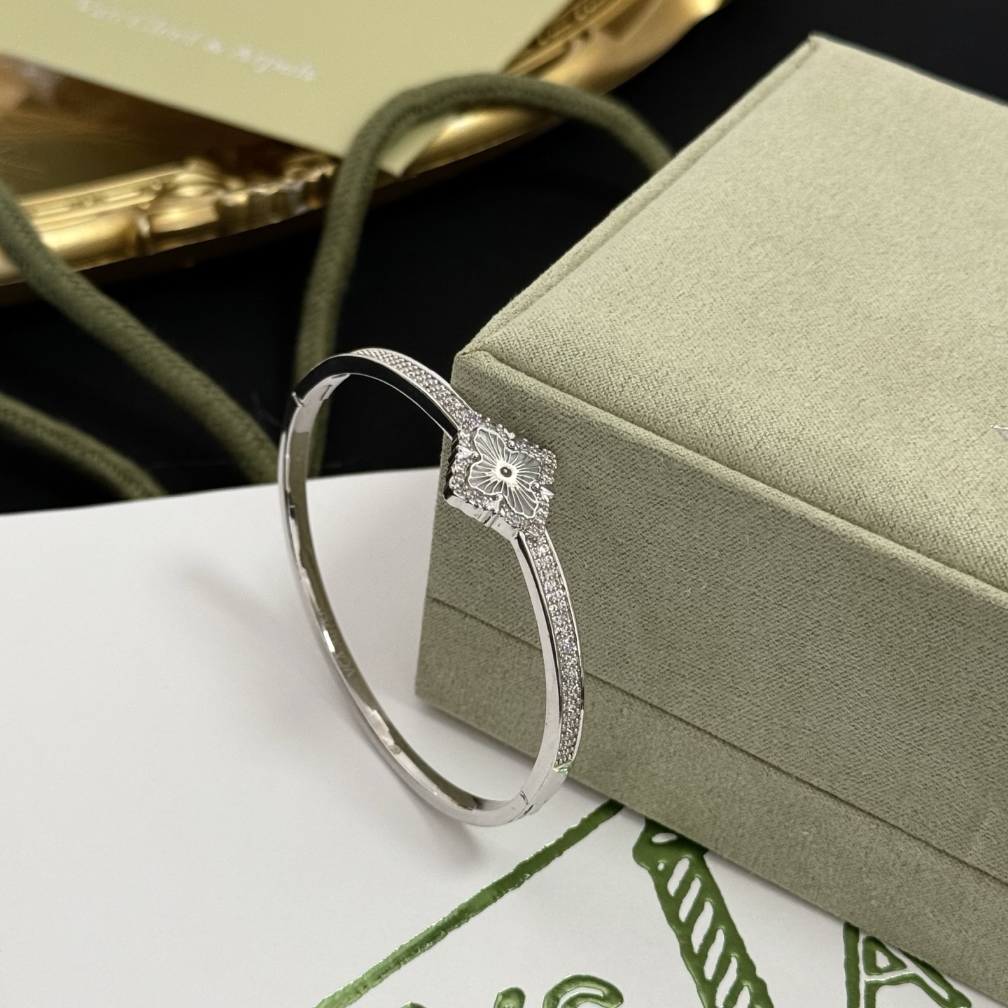 Van Cleef Arpels Alhambra bracelet silver-toned metal with clear diamond accents and silver guilloche clover motif 17cm