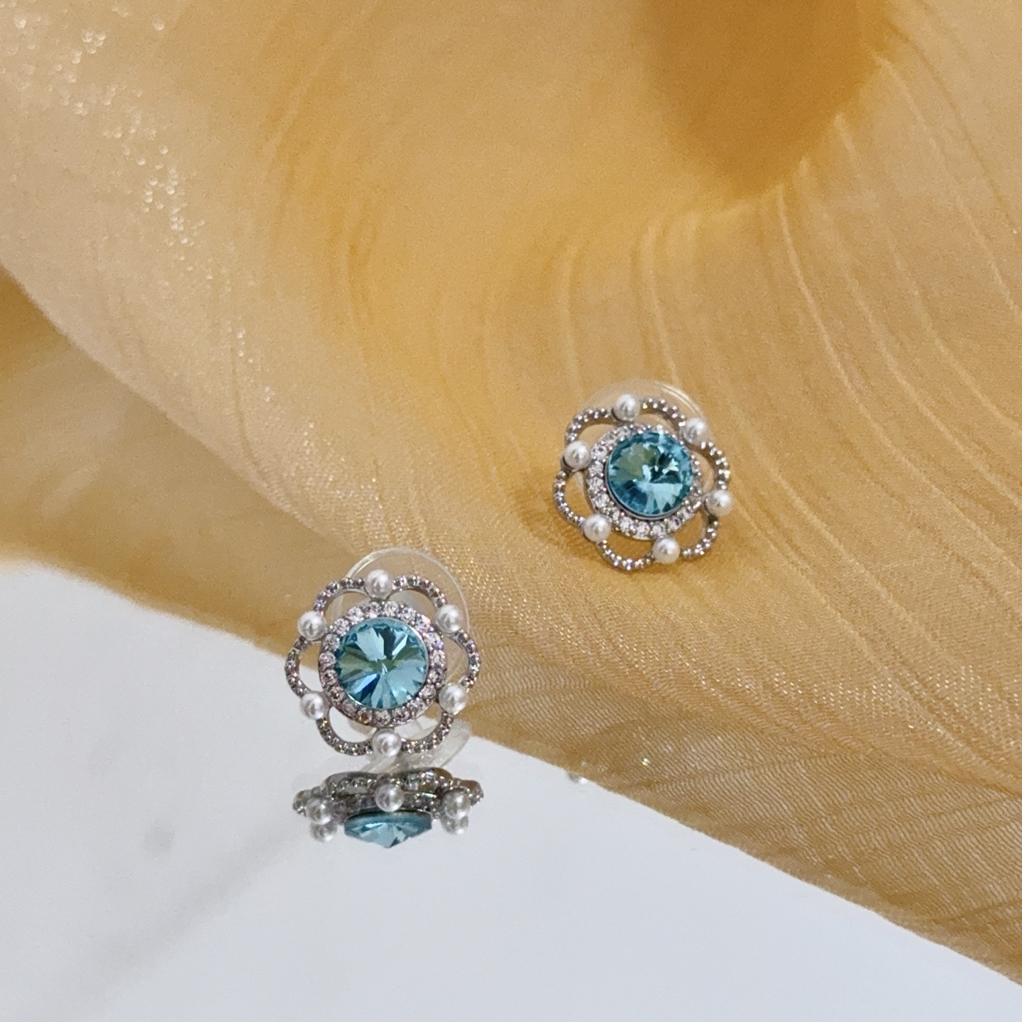 Piaget Rose earrings silver-toned white gold aqua blue central gemstone white diamond accents white pearl accents 10mm stud diameter