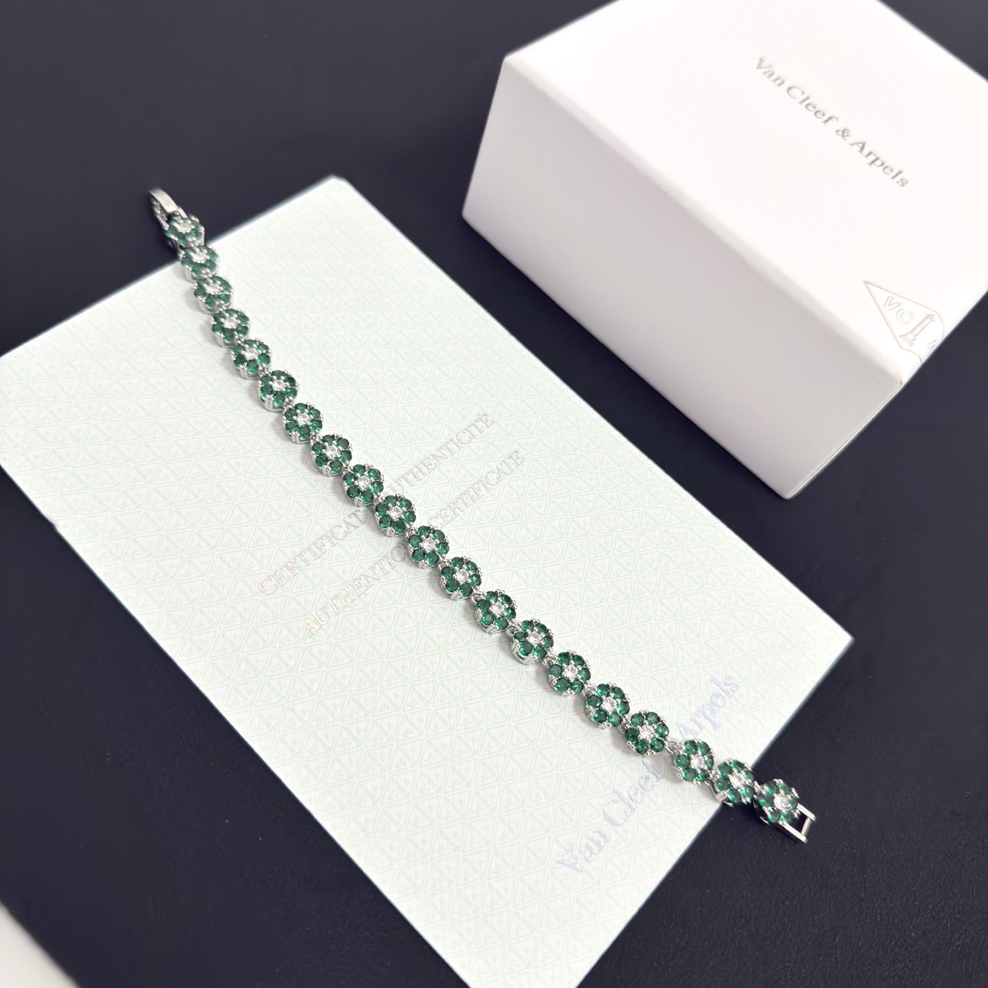Van Cleef Arpels Fleurette bracelet silver-toned white gold metal emerald green gemstones clear white diamonds 18cm