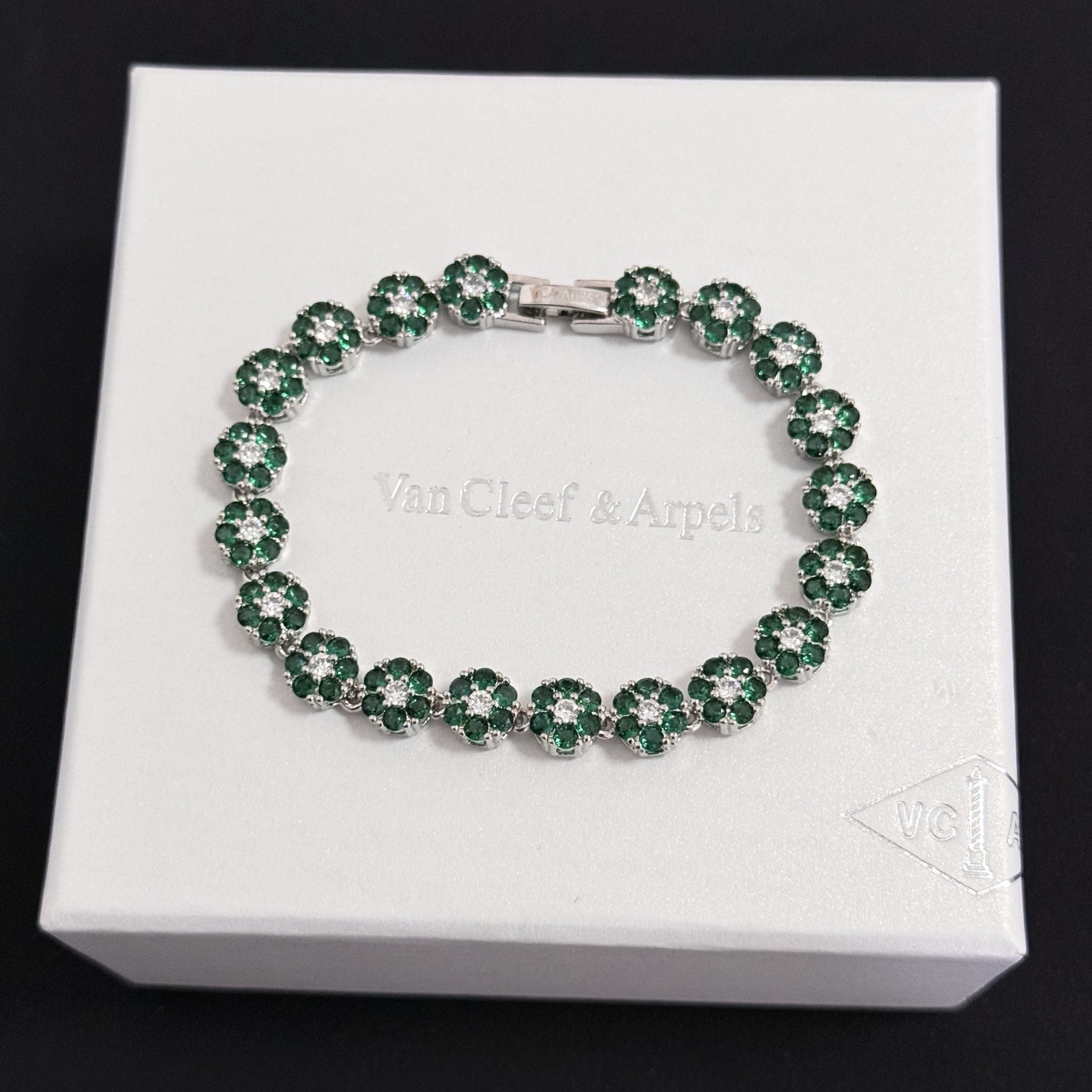 Van Cleef Arpels Fleurette bracelet silver-toned white gold metal emerald green gemstones clear white diamonds 18cm