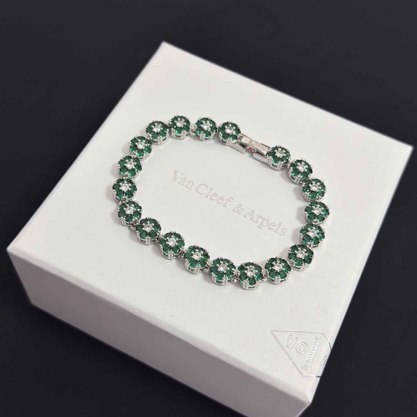 Van Cleef Arpels Fleurette bracelet silver-toned white gold metal emerald green gemstones clear white diamonds 18cm