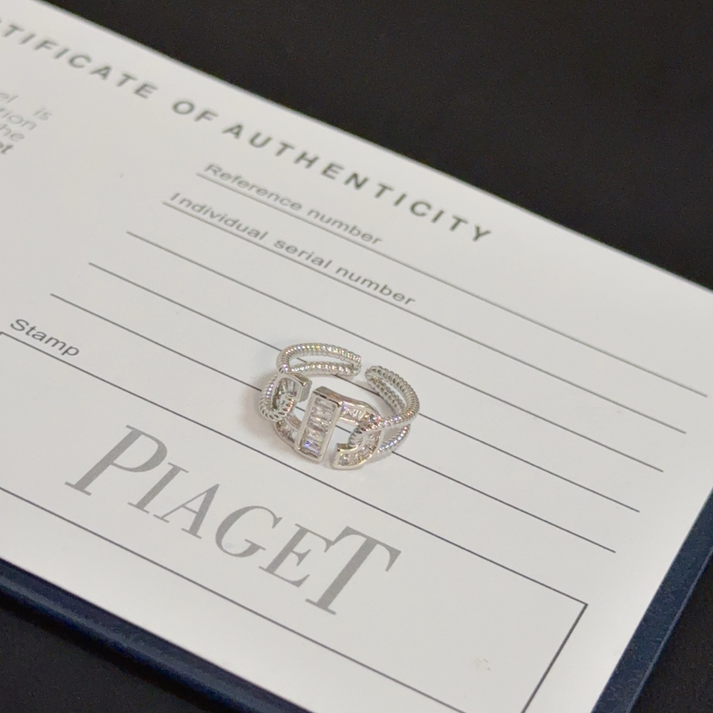 Piaget Possession ring silver-toned white gold with clear diamond accents adjustable open size