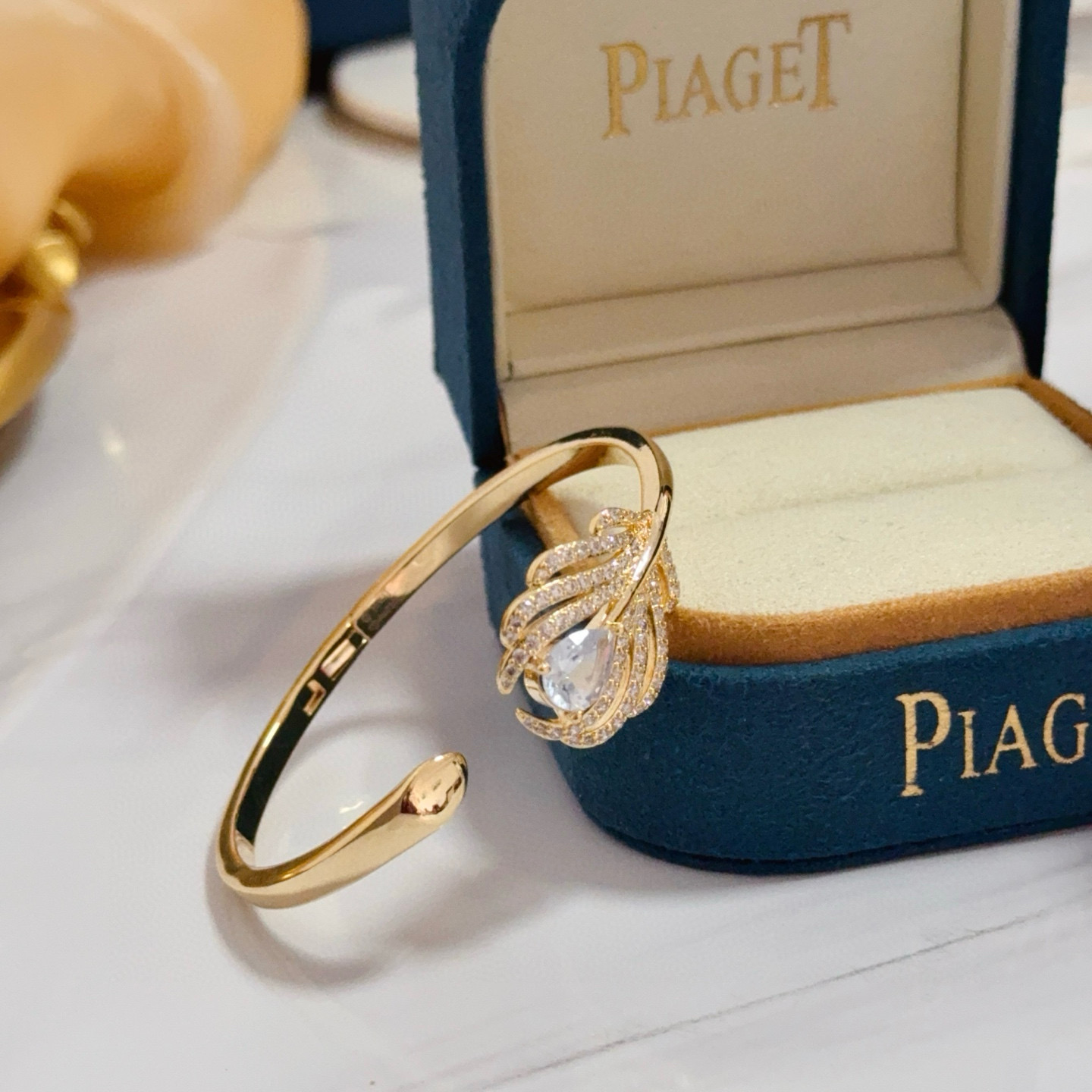 Piaget Feather Motif Open Cuff bracelet Yellow gold metal with clear faceted gemstones and pave-set clear accent stones 17cm inner circumference