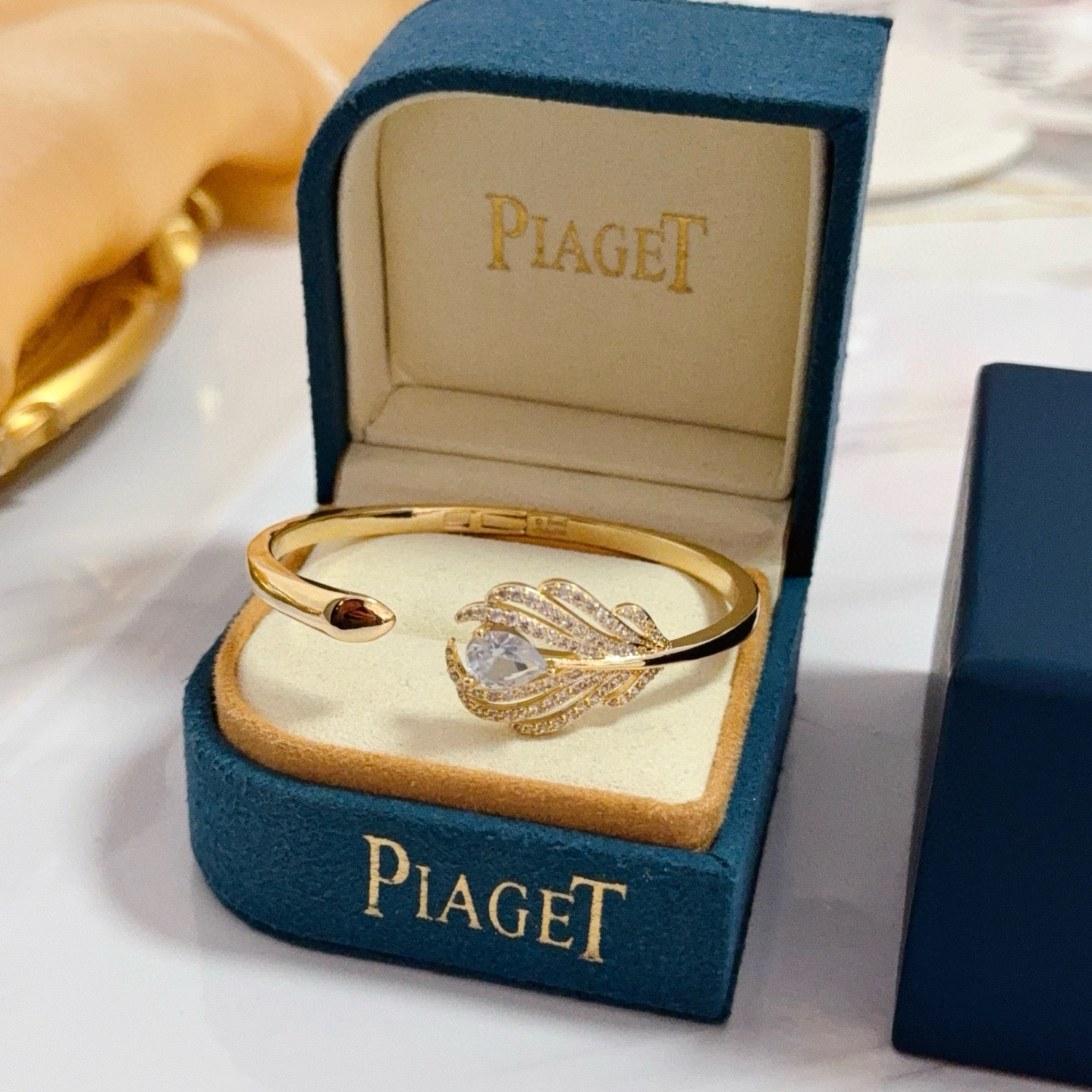 Piaget Feather Motif Open Cuff bracelet Yellow gold metal with clear faceted gemstones and pave-set clear accent stones 17cm inner circumference