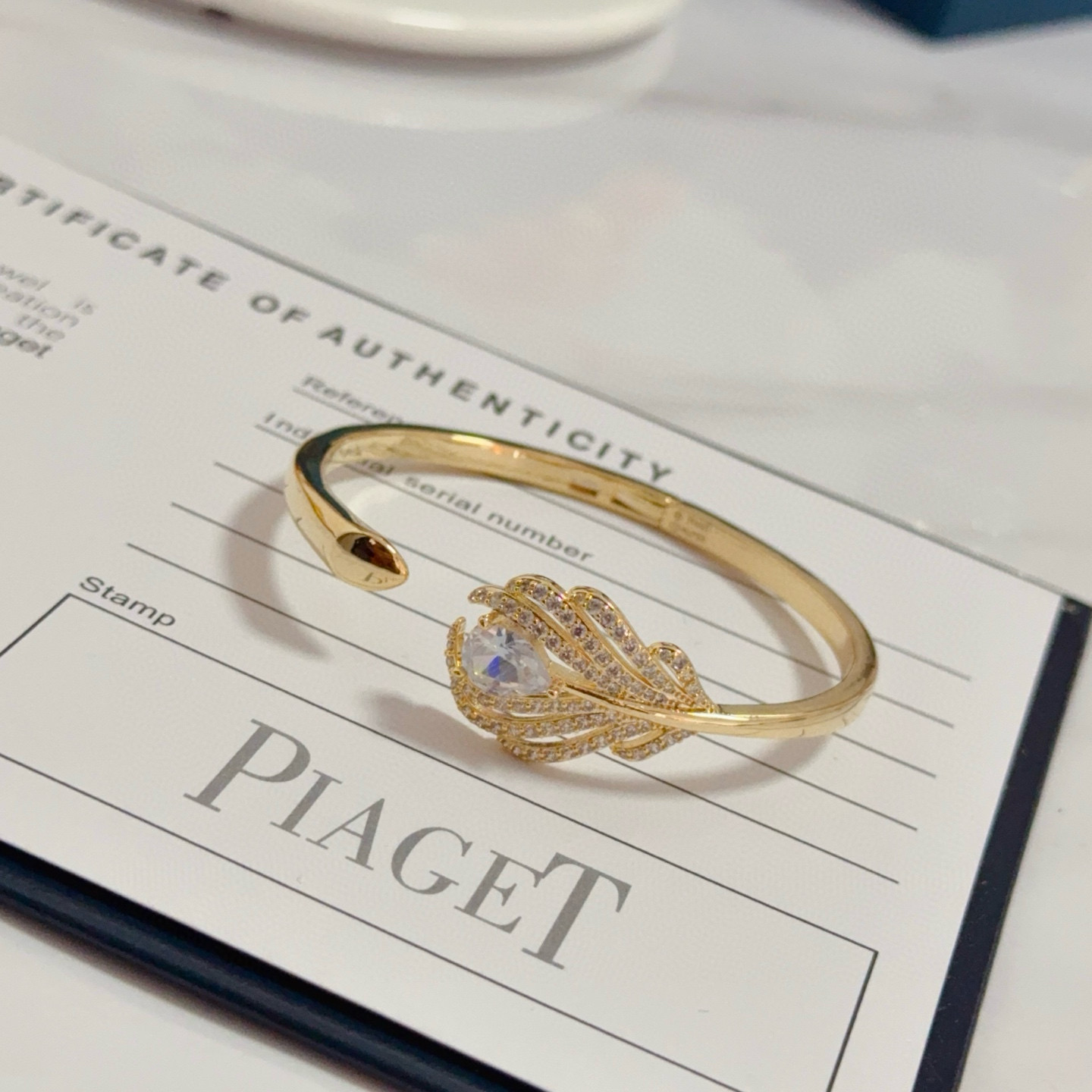 Piaget Feather Motif Open Cuff bracelet Yellow gold metal with clear faceted gemstones and pave-set clear accent stones 17cm inner circumference