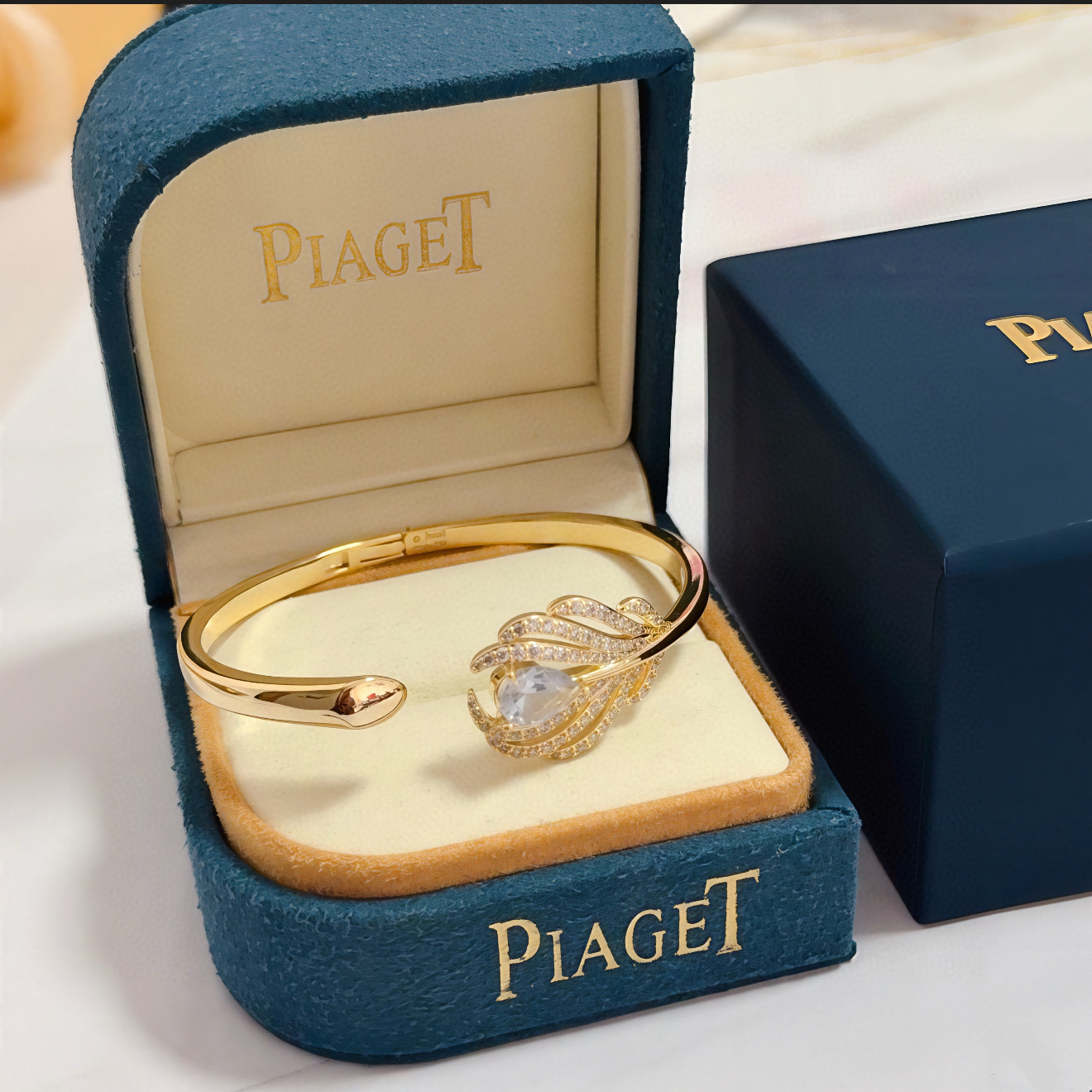 Piaget Feather Motif Open Cuff bracelet Yellow gold metal with clear faceted gemstones and pave-set clear accent stones 17cm inner circumference