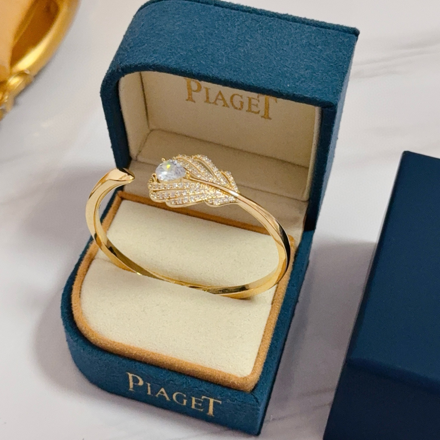 Piaget Feather Motif Open Cuff bracelet Yellow gold metal with clear faceted gemstones and pave-set clear accent stones 17cm inner circumference