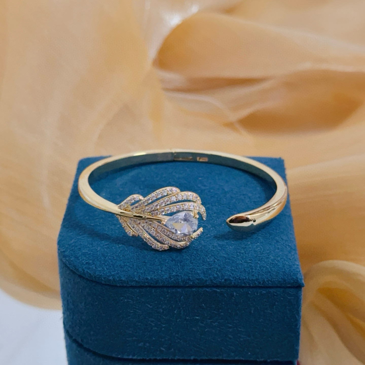 Piaget Feather Motif Open Cuff bracelet Yellow gold metal with clear faceted gemstones and pave-set clear accent stones 17cm inner circumference