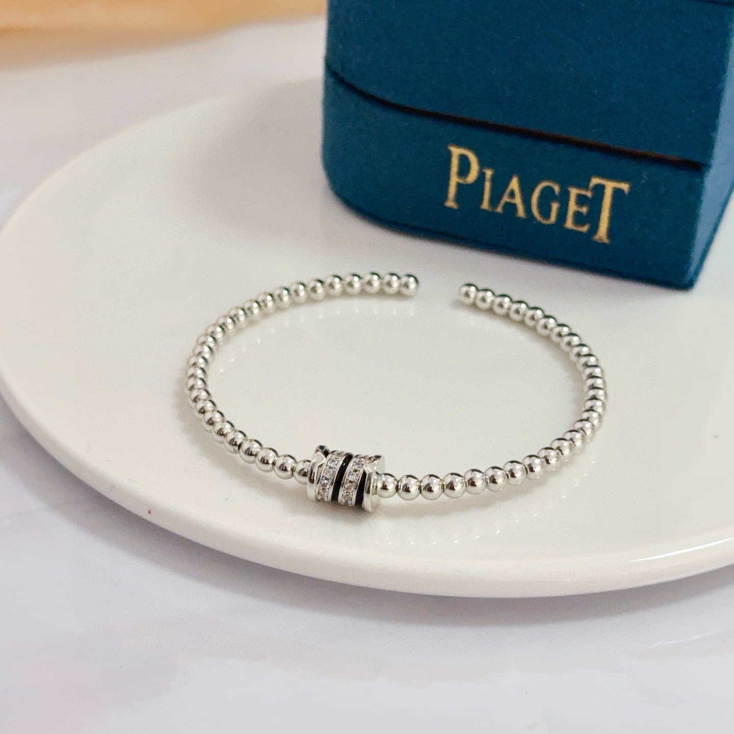 Piaget Possession bracelet silver-toned white gold with clear diamond accents and black enamel detailing 17cm