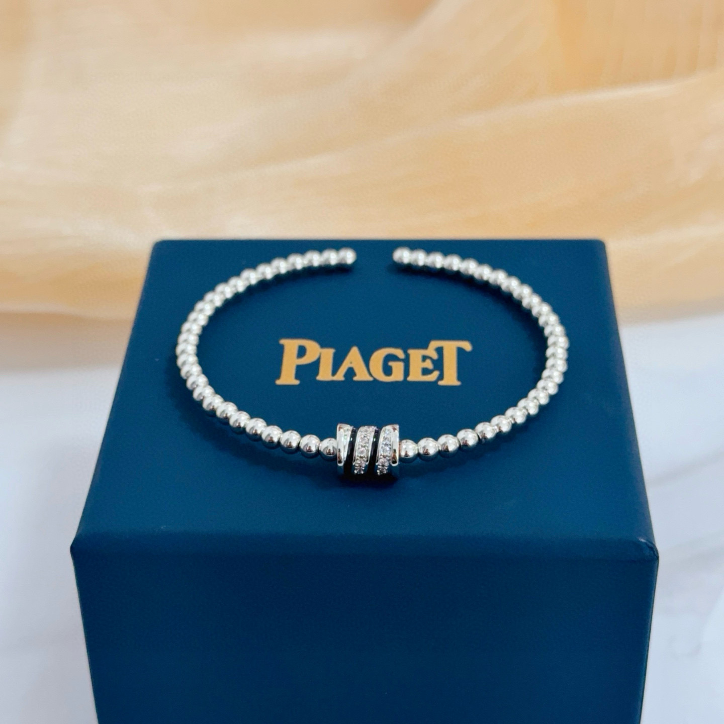 Piaget Possession bracelet silver-toned white gold with clear diamond accents and black enamel detailing 17cm