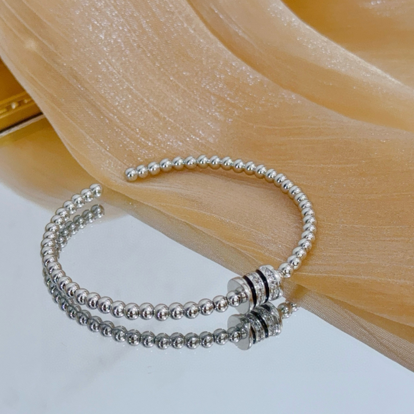 Piaget Possession bracelet silver-toned white gold with clear diamond accents and black enamel detailing 17cm