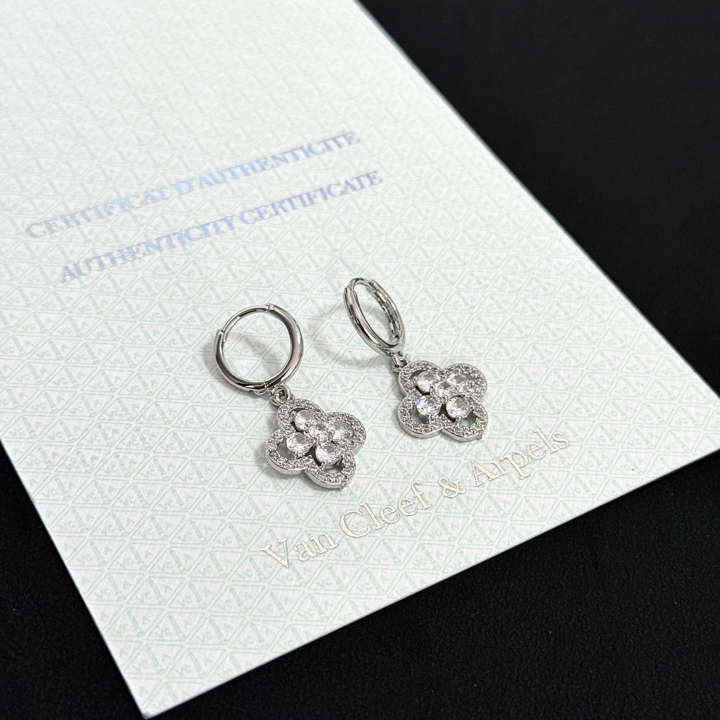 Van Cleef Arpels Alhambra earrings silver-toned white gold metal clear diamond-like gemstones 12mm hoop diameter 10mm charm