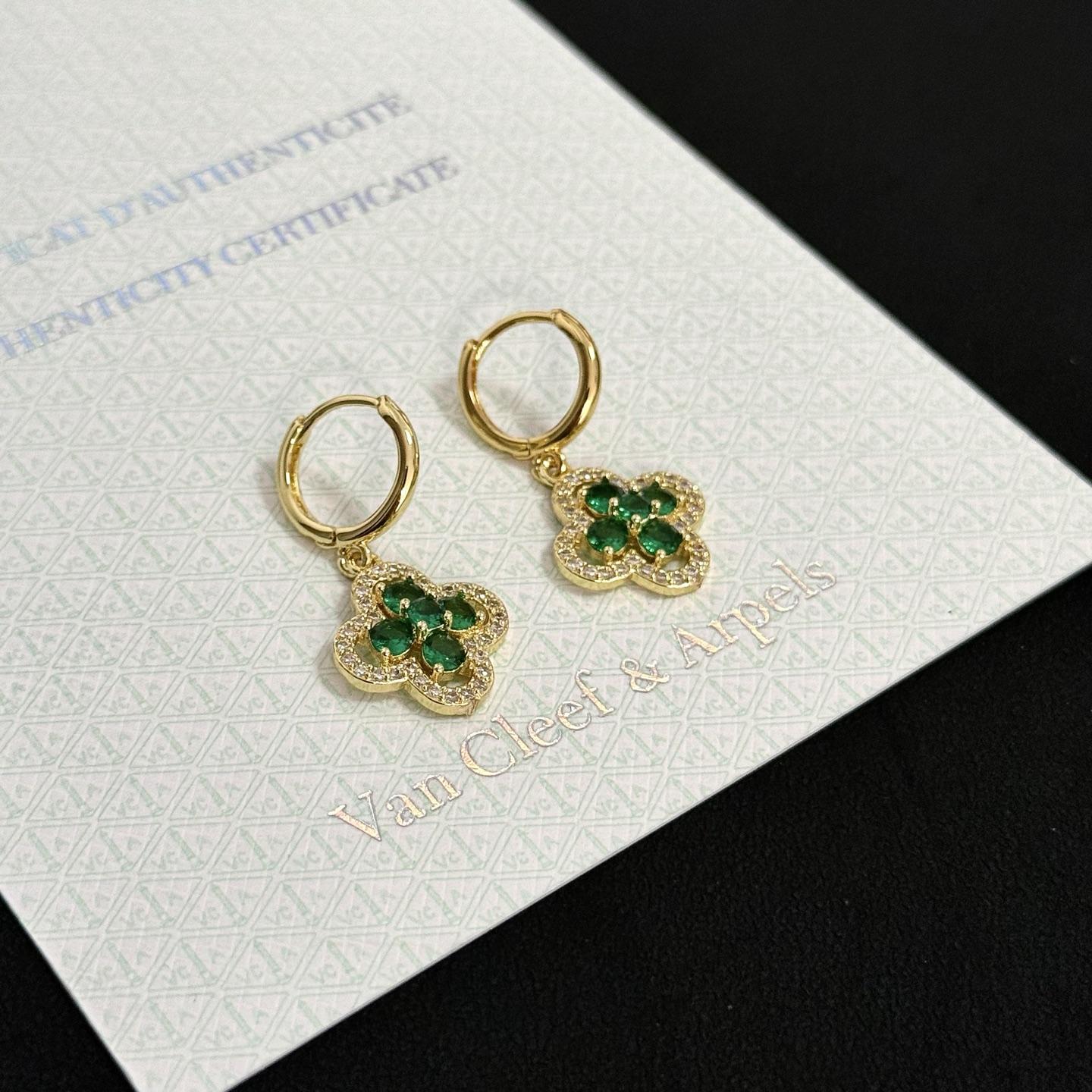 Van Cleef Arpels Alhambra earrings yellow gold metal with emerald green gemstones and clear diamond accents 12mm hoop diameter 10mm charm