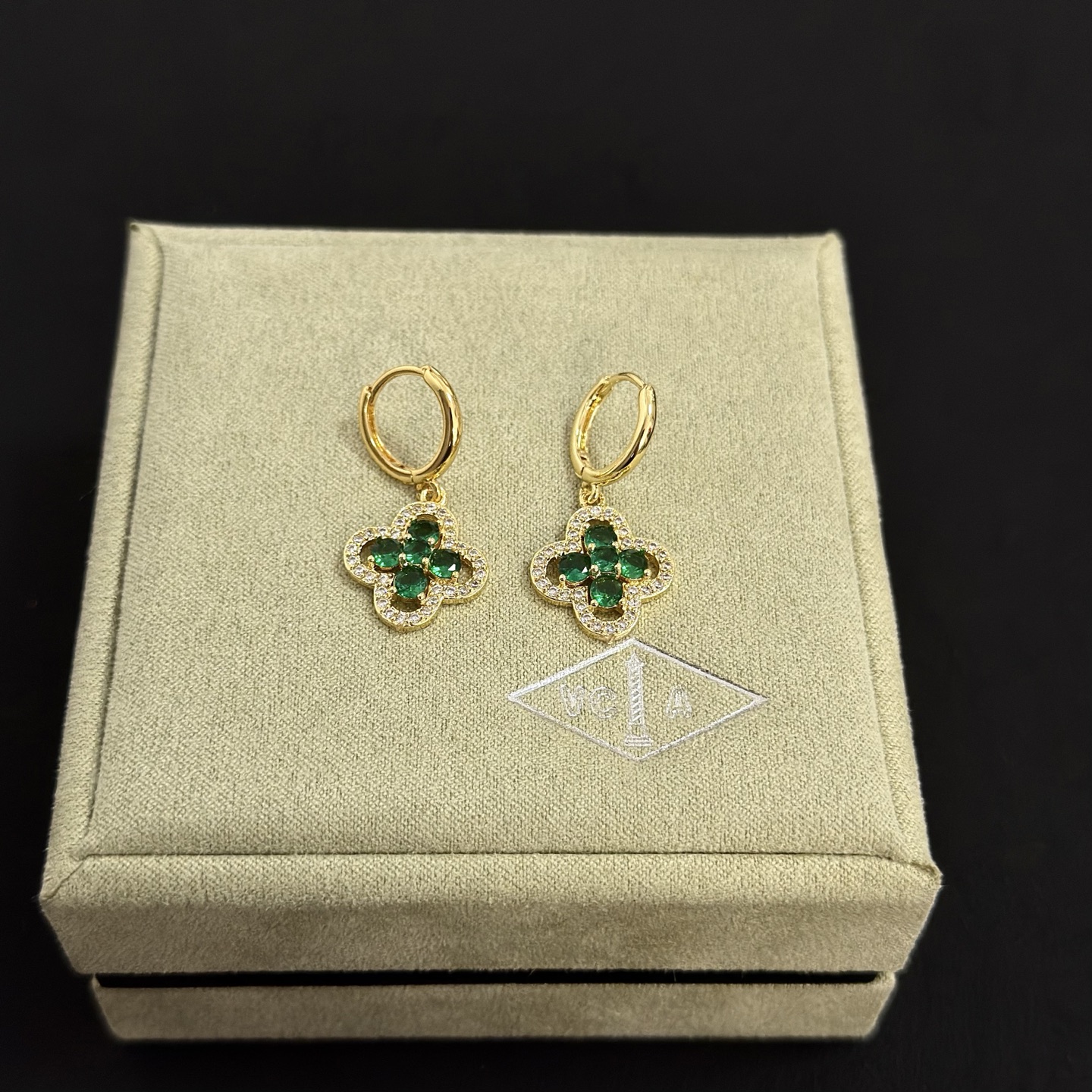 Van Cleef Arpels Alhambra earrings yellow gold metal with emerald green gemstones and clear diamond accents 12mm hoop diameter 10mm charm
