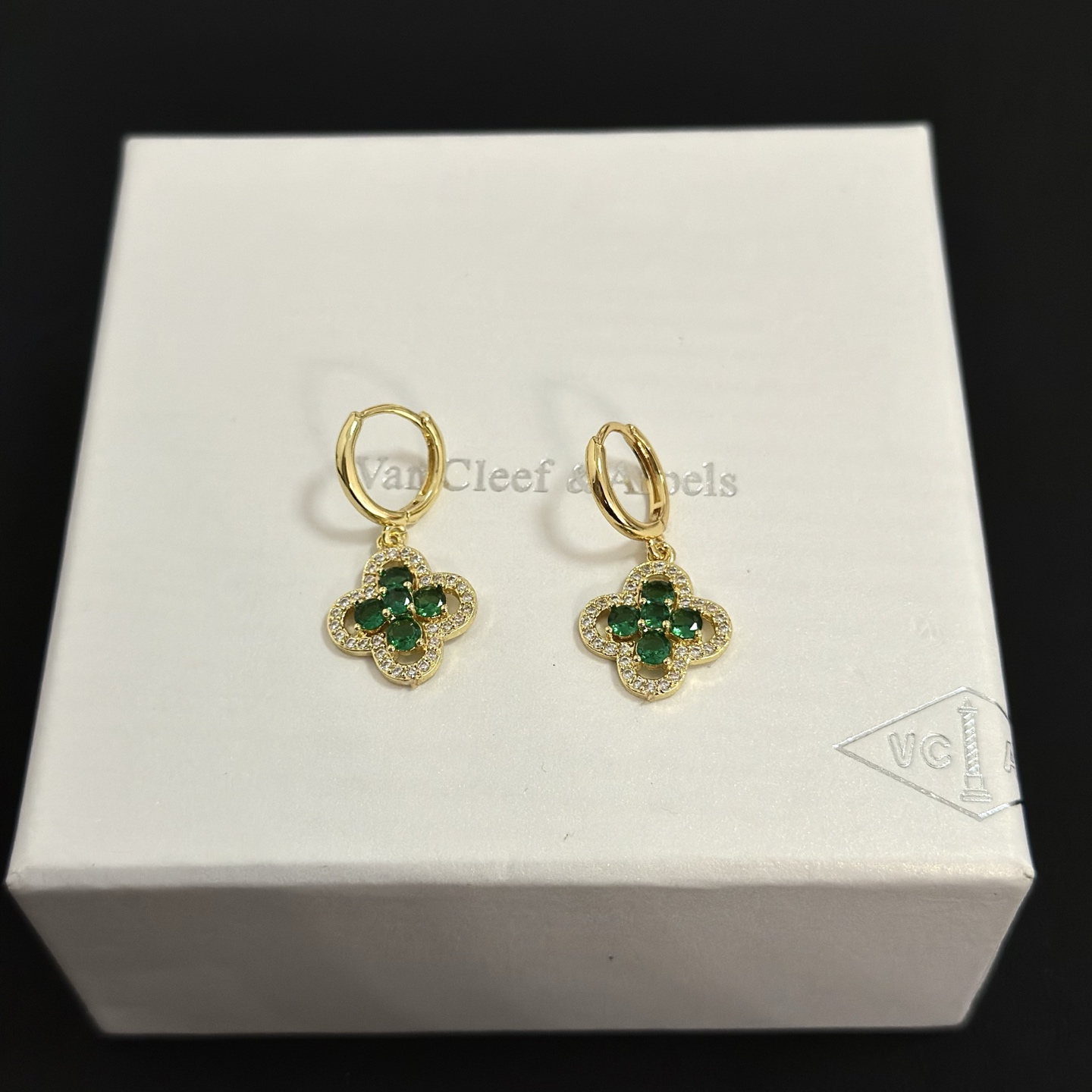 Van Cleef Arpels Alhambra earrings yellow gold metal with emerald green gemstones and clear diamond accents 12mm hoop diameter 10mm charm