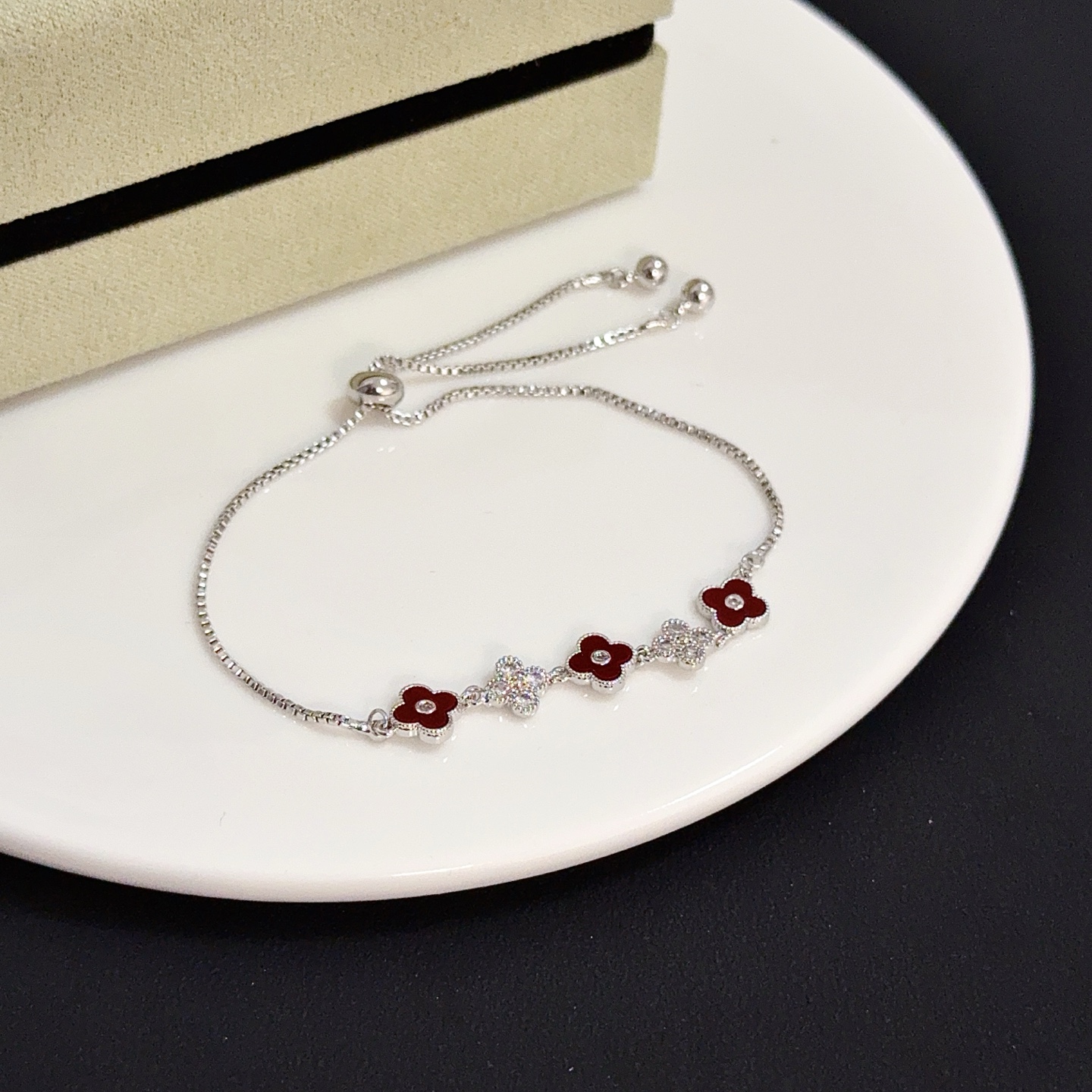 Van Cleef Arpels Alhambra bracelet silver-toned metal deep red carnelian-style enamel clear diamond accents adjustable slider chain 16-20cm