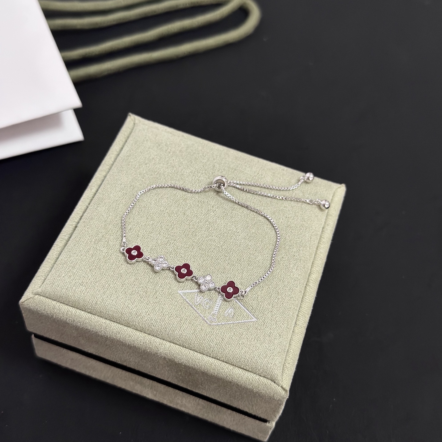Van Cleef Arpels Alhambra bracelet silver-toned metal deep red carnelian-style enamel clear diamond accents adjustable slider chain 16-20cm