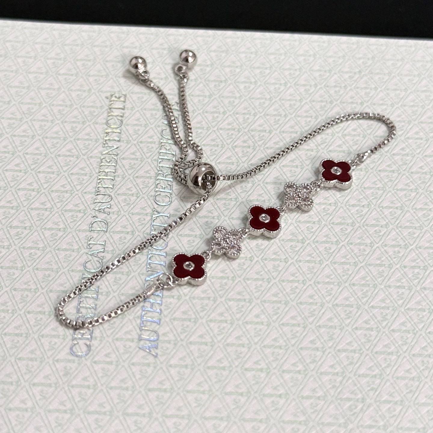 Van Cleef Arpels Alhambra bracelet silver-toned metal deep red carnelian-style enamel clear diamond accents adjustable slider chain 16-20cm