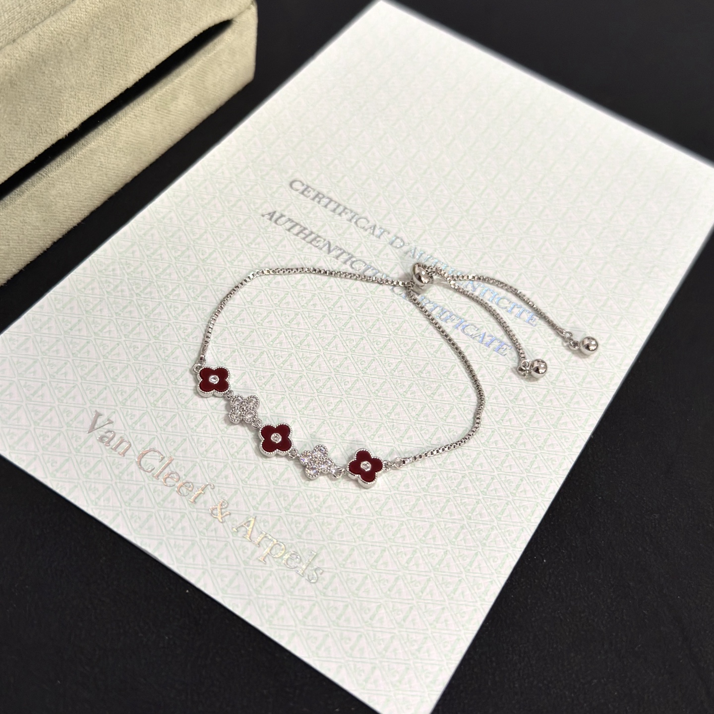 Van Cleef Arpels Alhambra bracelet silver-toned metal deep red carnelian-style enamel clear diamond accents adjustable slider chain 16-20cm
