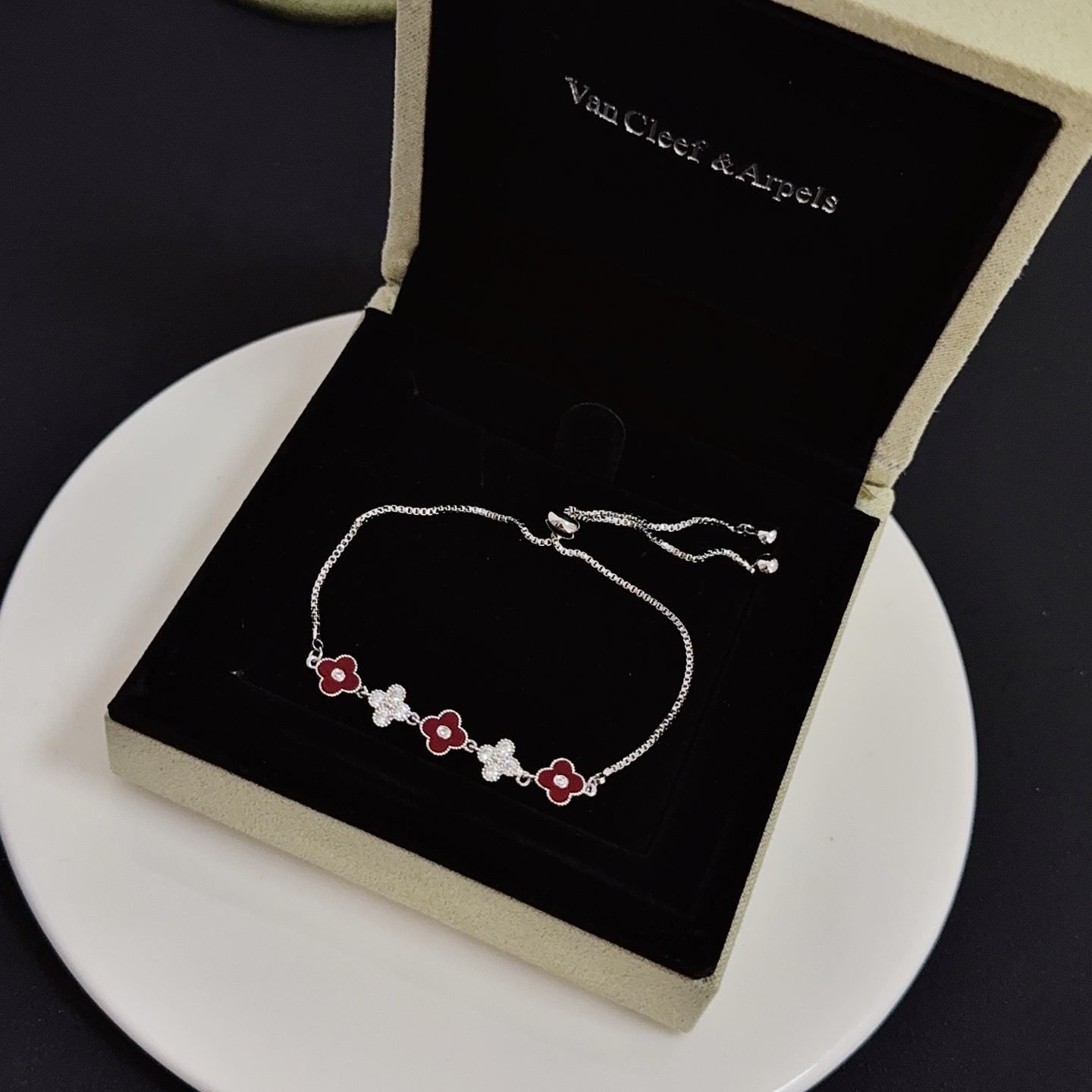 Van Cleef Arpels Alhambra bracelet silver-toned metal deep red carnelian-style enamel clear diamond accents adjustable slider chain 16-20cm