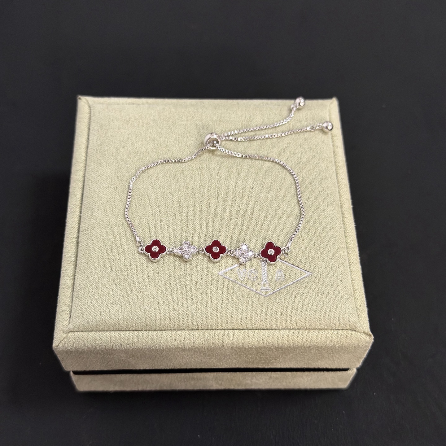 Van Cleef Arpels Alhambra bracelet silver-toned metal deep red carnelian-style enamel clear diamond accents adjustable slider chain 16-20cm